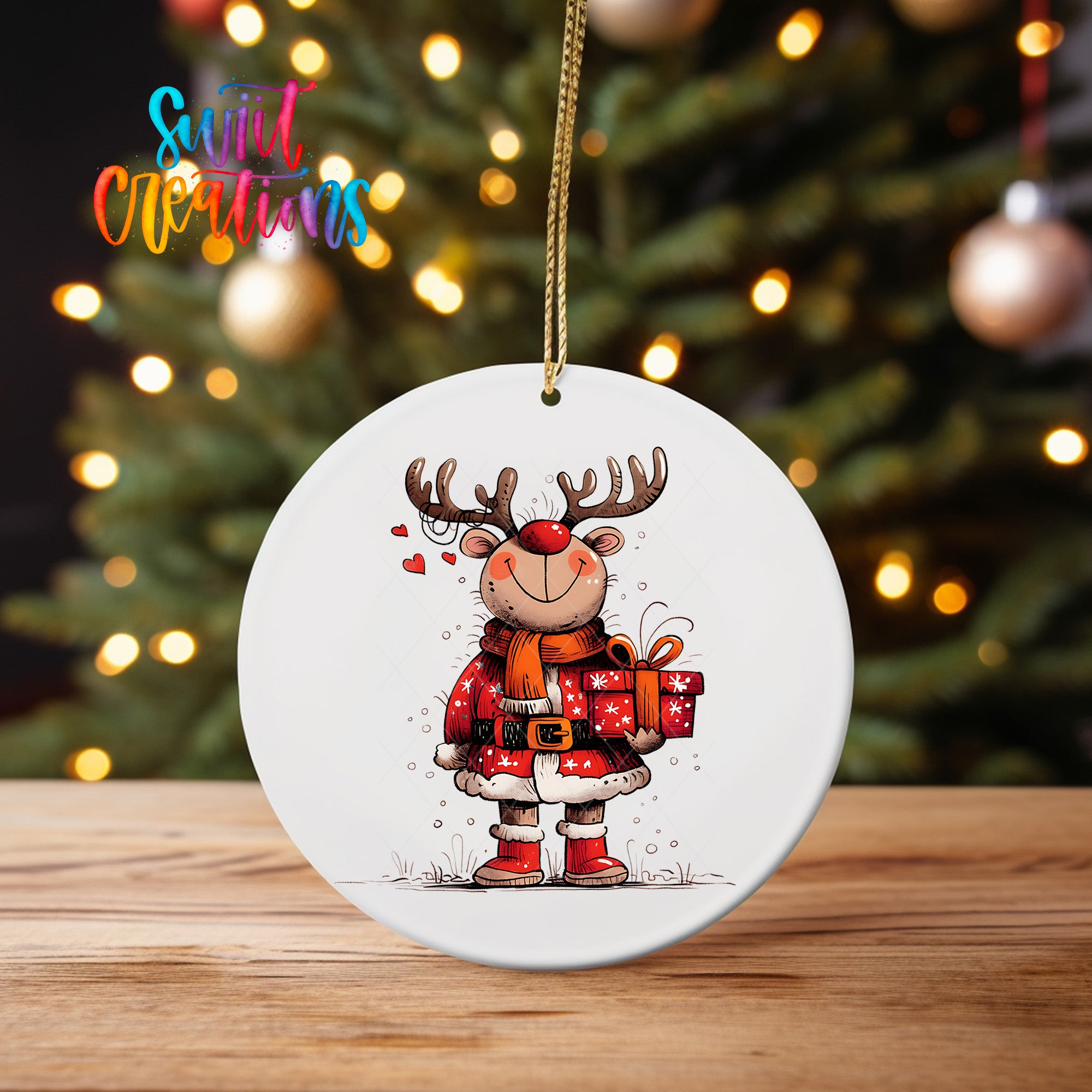 A white oval ornament featuring a cartoon reindeer holding a gift box and smiling, with a blurred background of a Christmas tree and colorful lights.