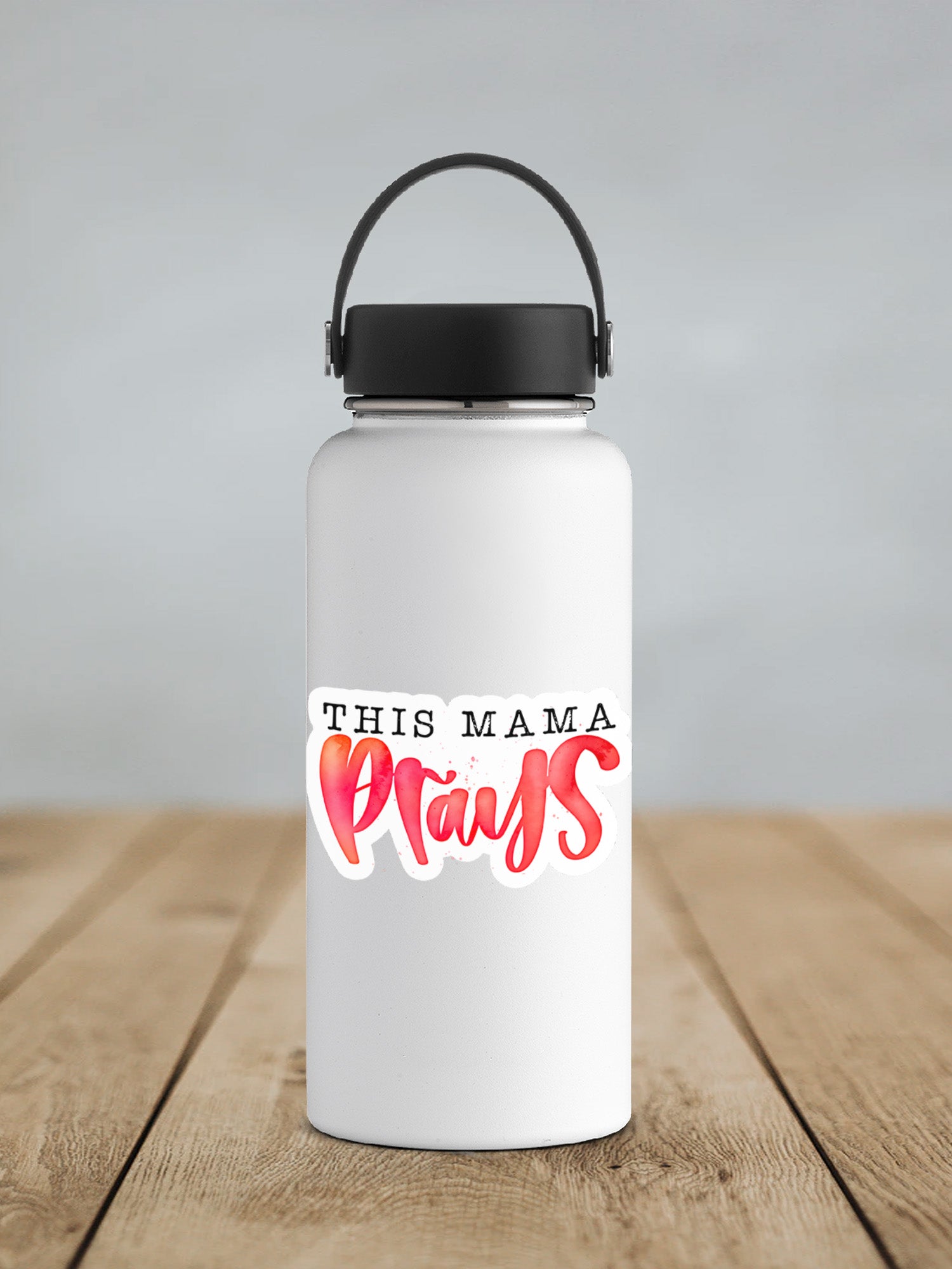 a white water bottle with the words this mama prays on it