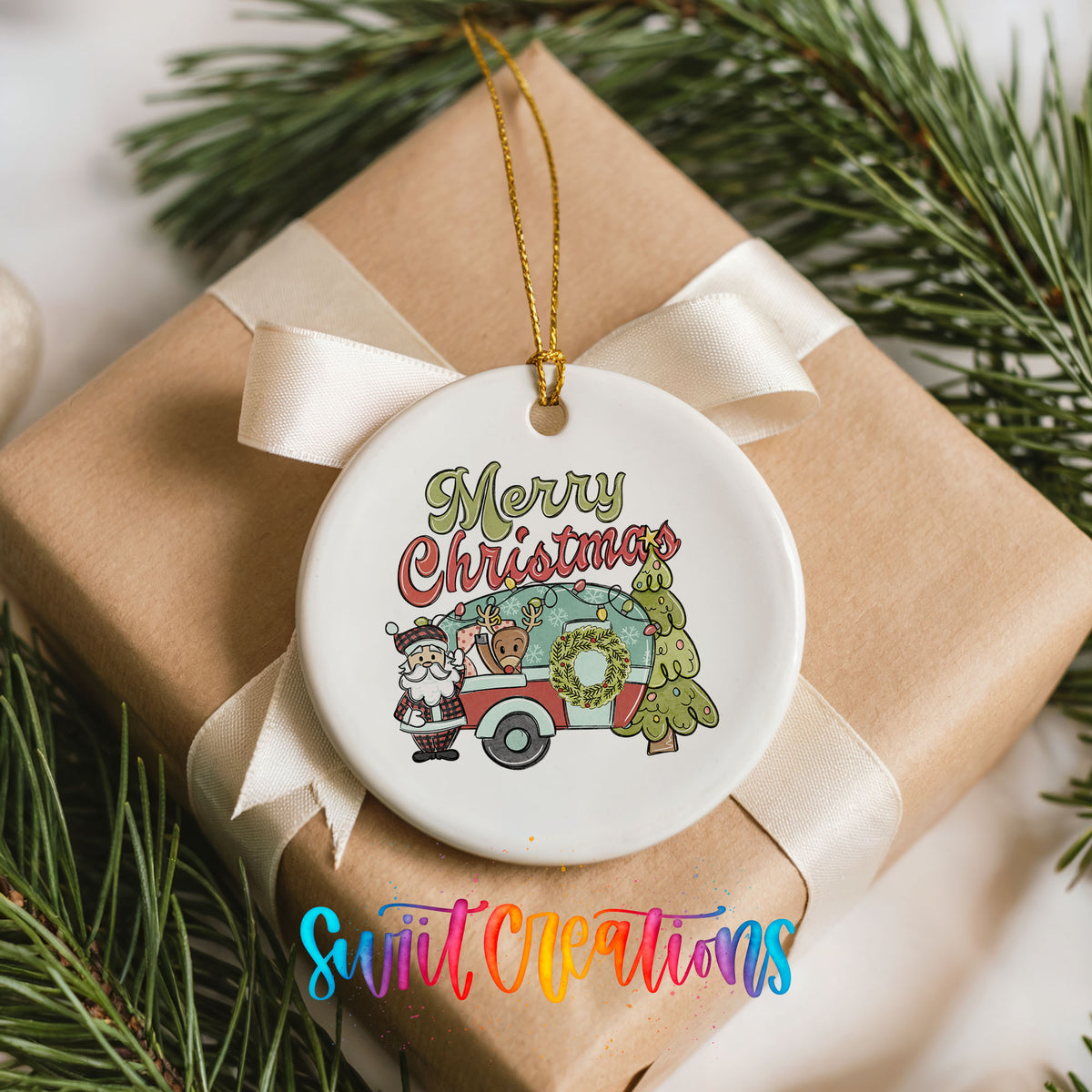 Merry Christmas Santa Camper ceramic Christmas ornament placed on a wrapped Christmas gift