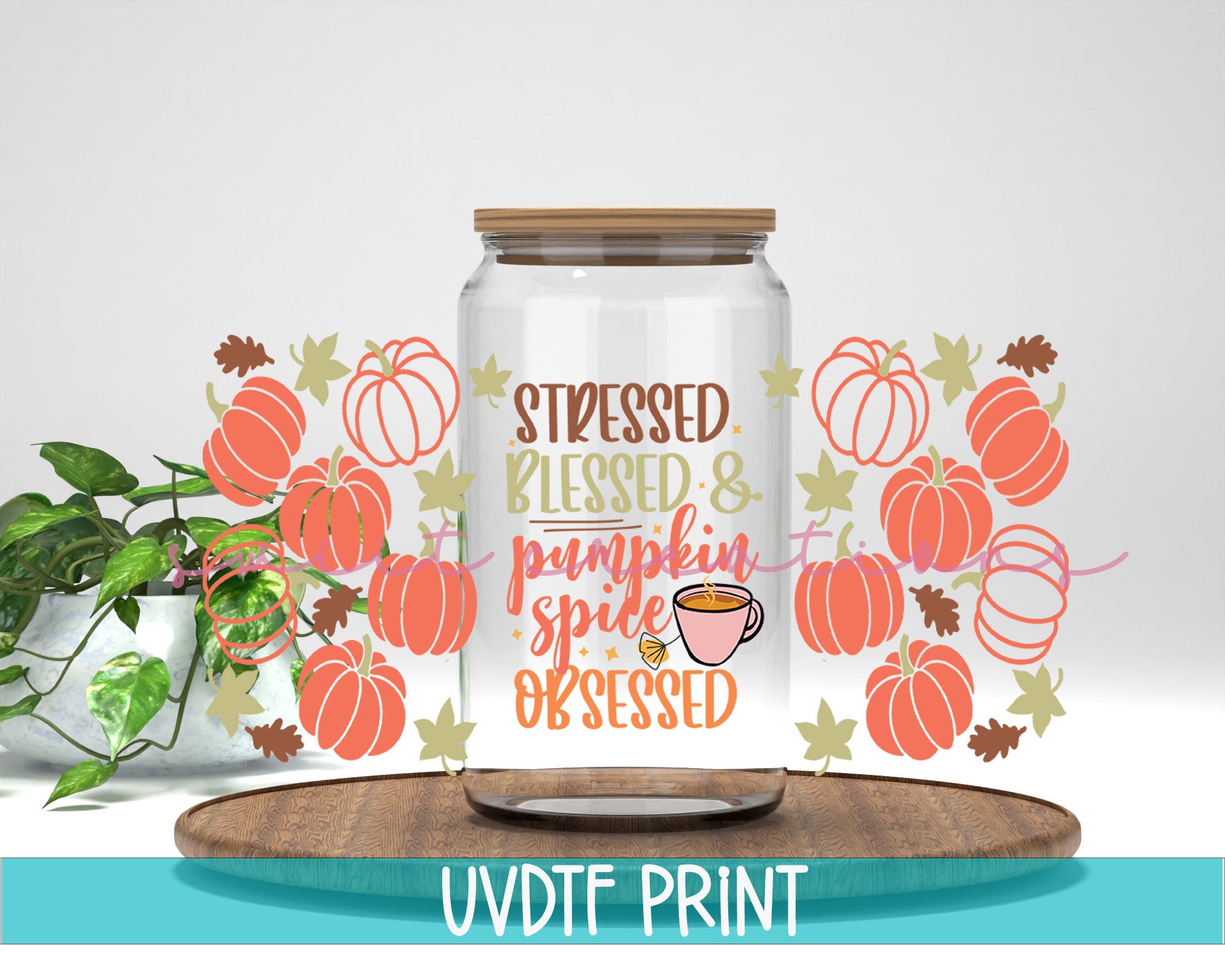 a glass jar with a saying on it next to a potted plant