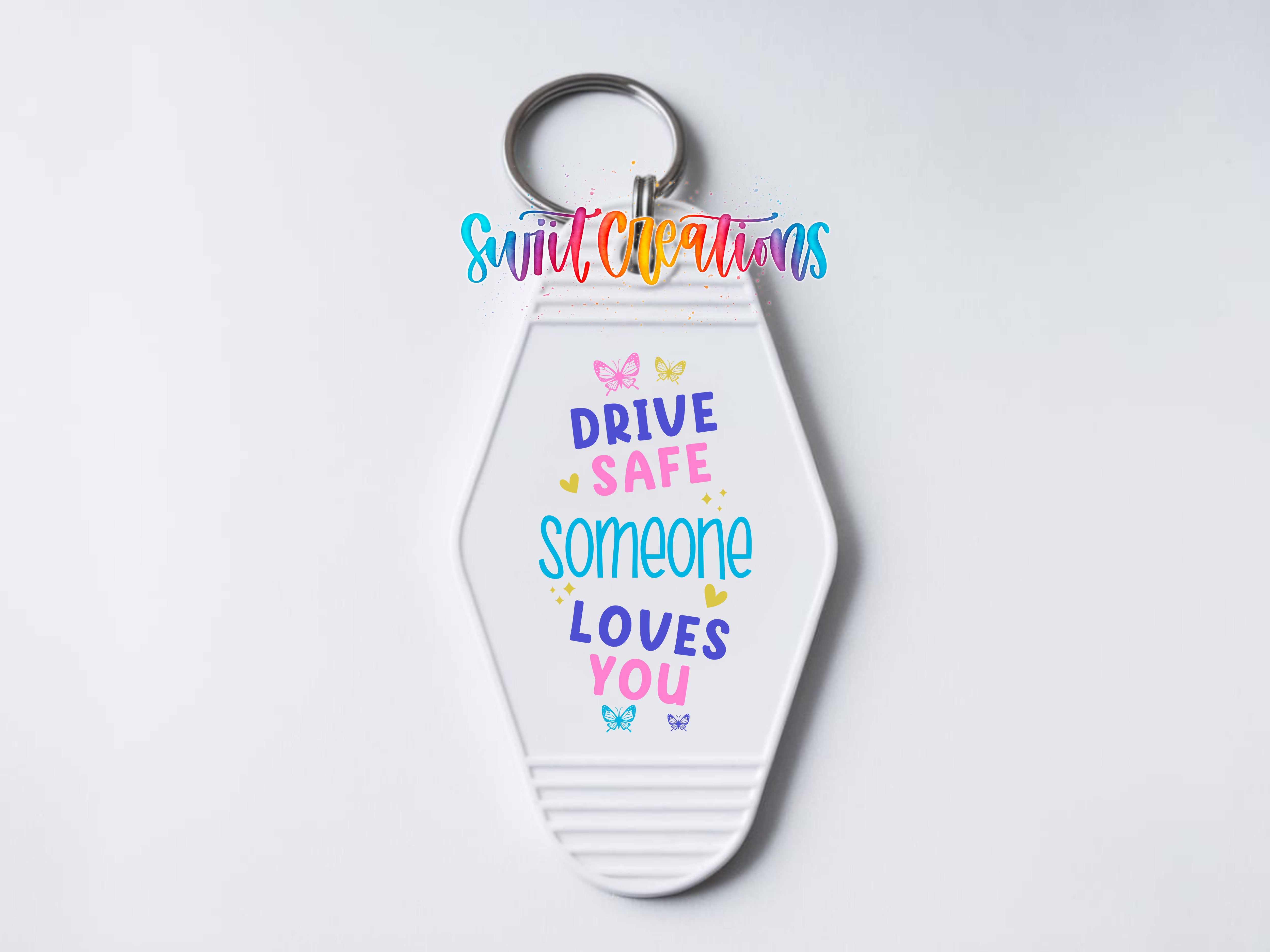 A keychain with a message that reads "DRIVE SAFE SOMEONE LOVES YOU" in a colorful, playful font.