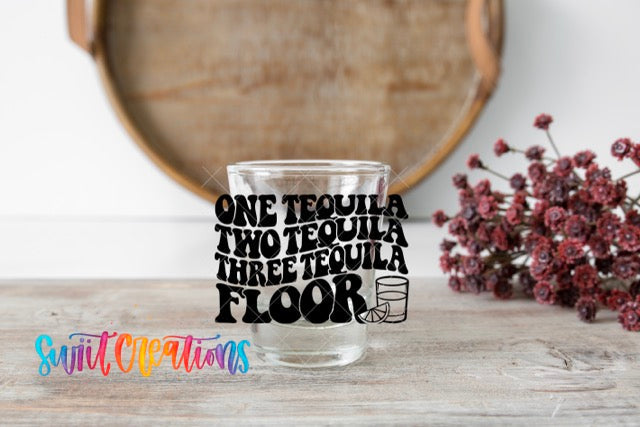 a shot glass sitting on top of a wooden table