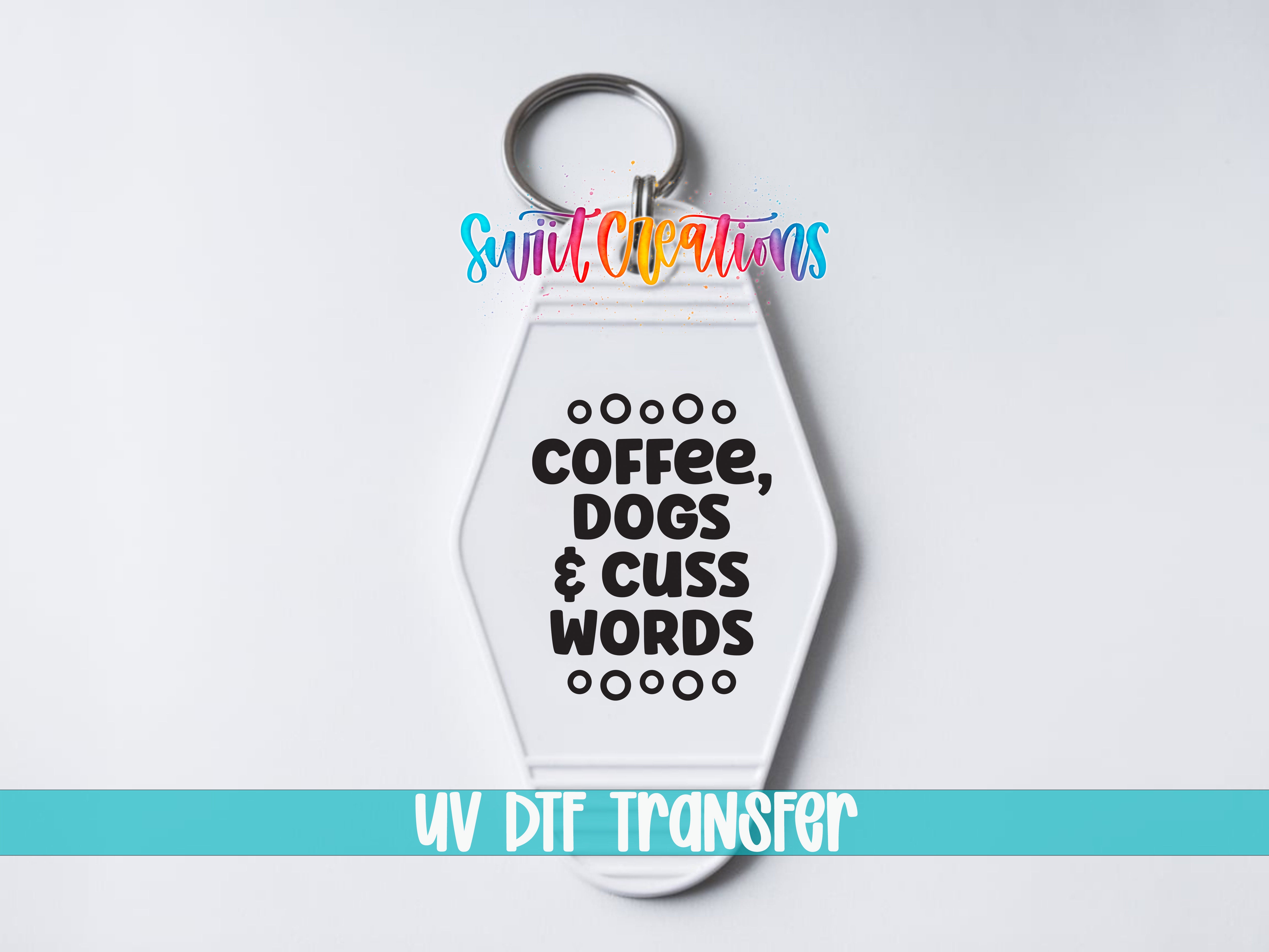 A keychain with the text "COFFEE, DOGS & CUSS WORDS" printed on it, along with a UV dye transfer logo.