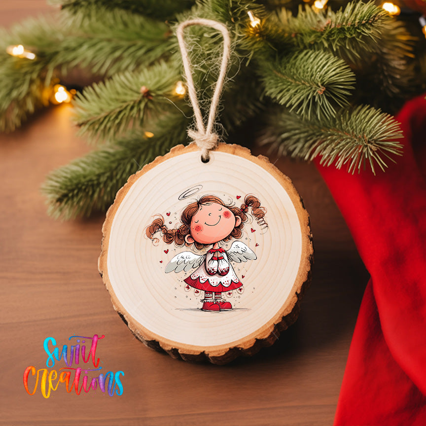 A wooden ornament featuring a smiling cartoon girl with wings, hanging on a Christmas tree.