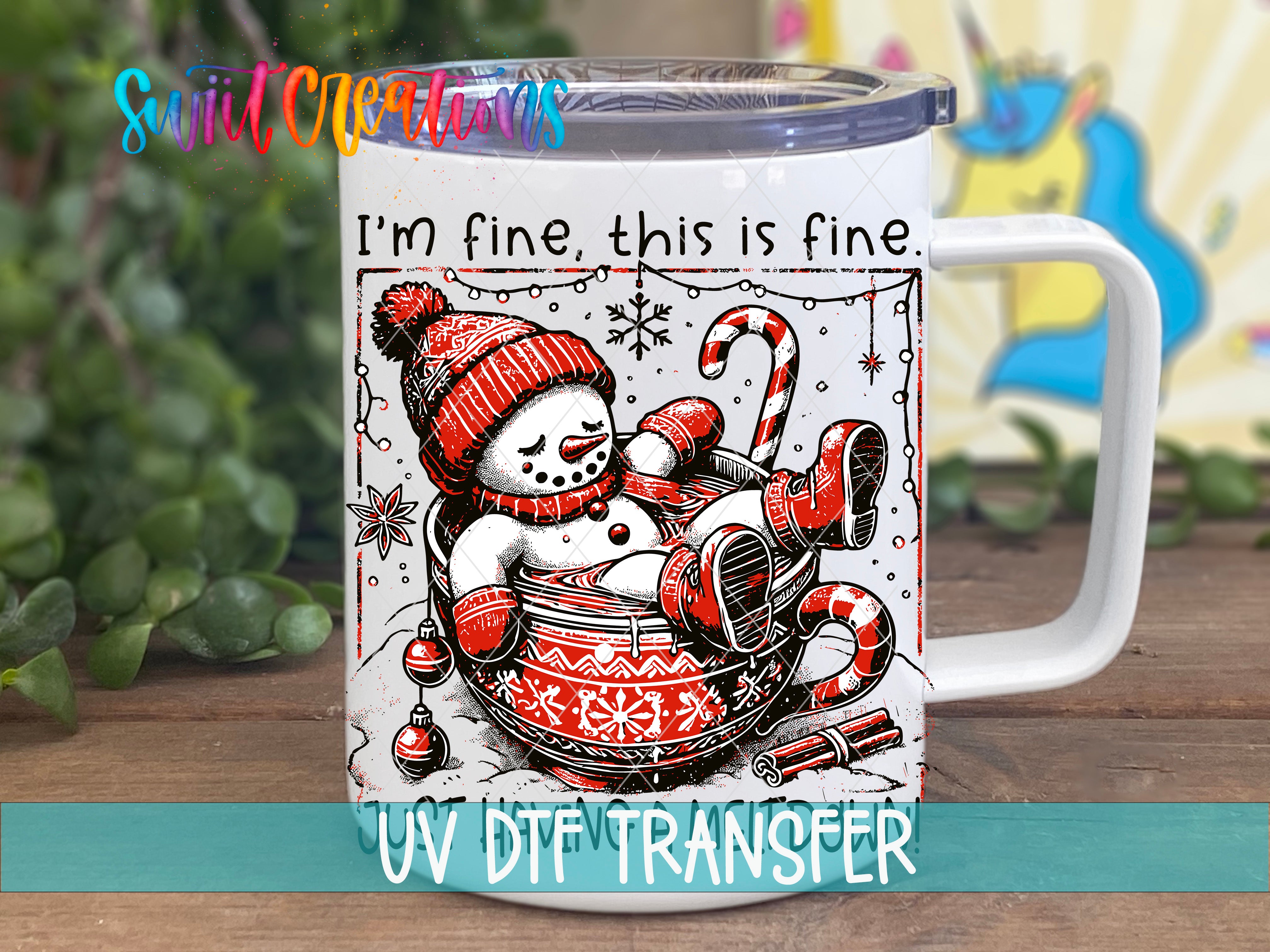 A mug with a snowman and Christmas decorations on it, along with the text "I'm fine, this is fine" and "UV DFT Transfer".