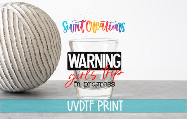 a ball of yarn next to a glass of water