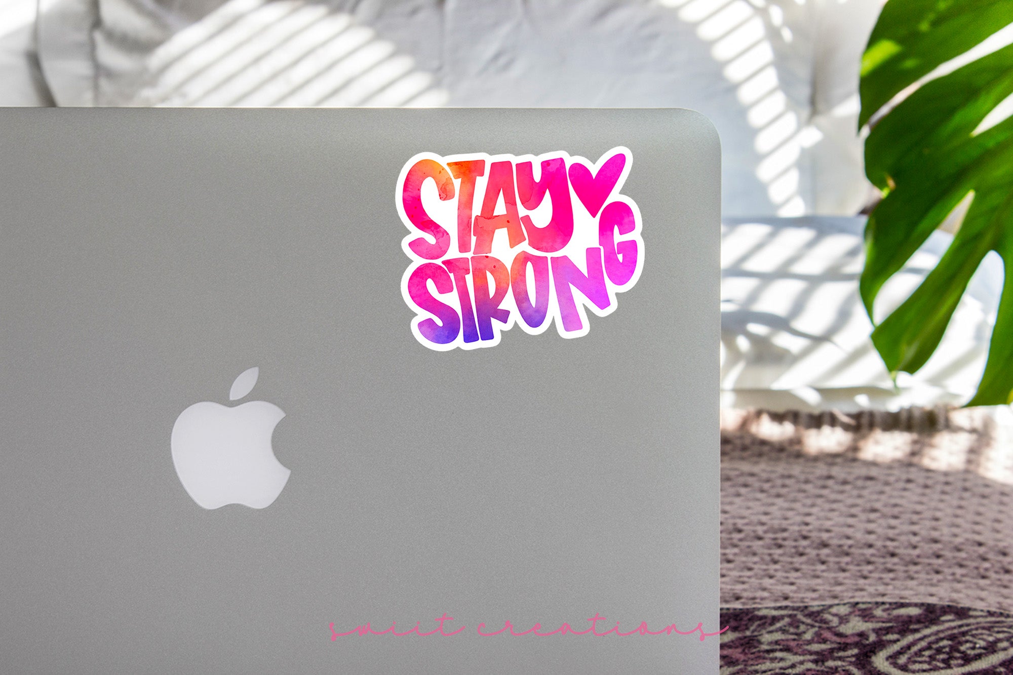 a laptop with a sticker that says stay strong