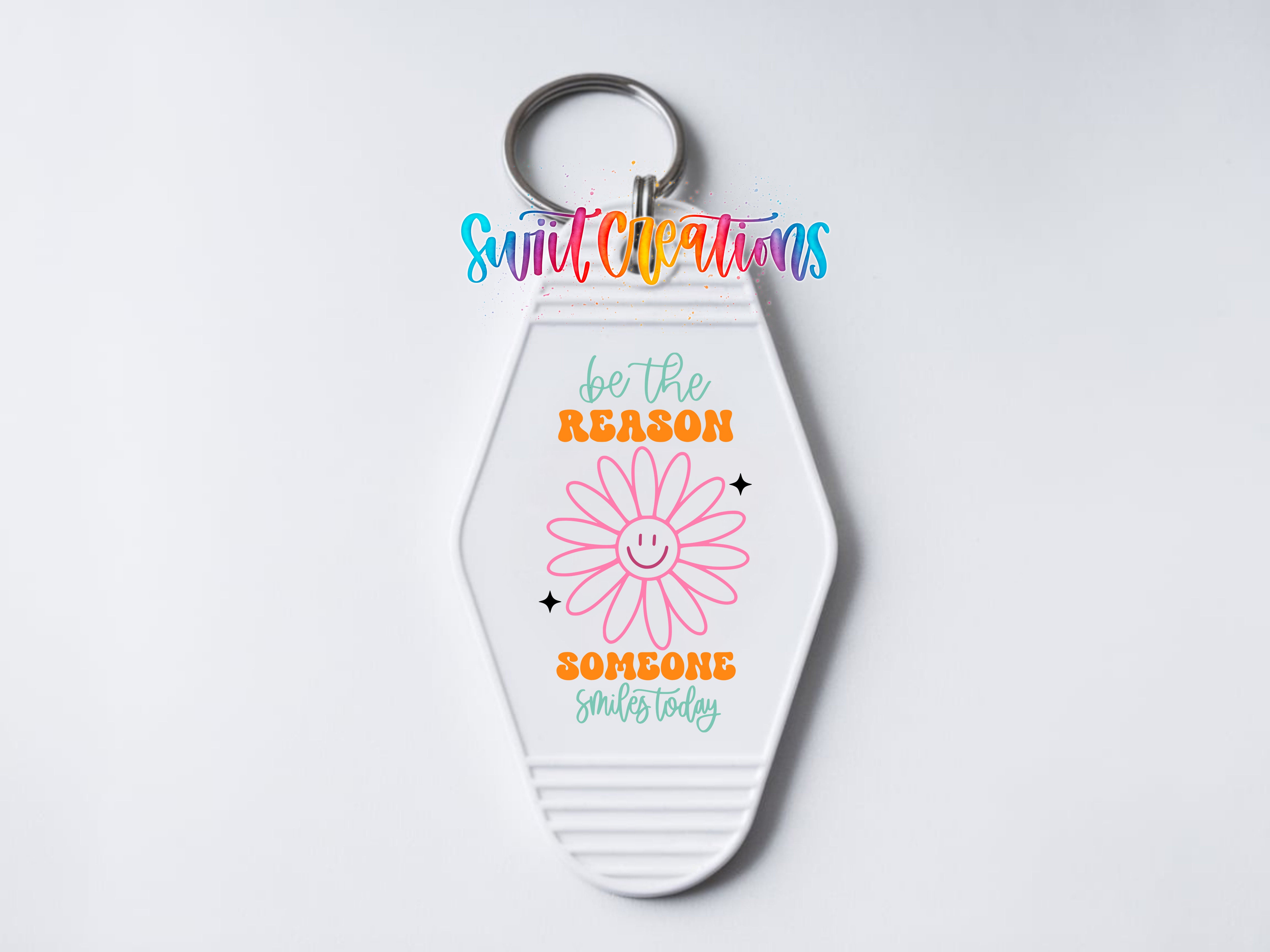 A keychain with a flower design and text that says "Be the reason someone smiles today".