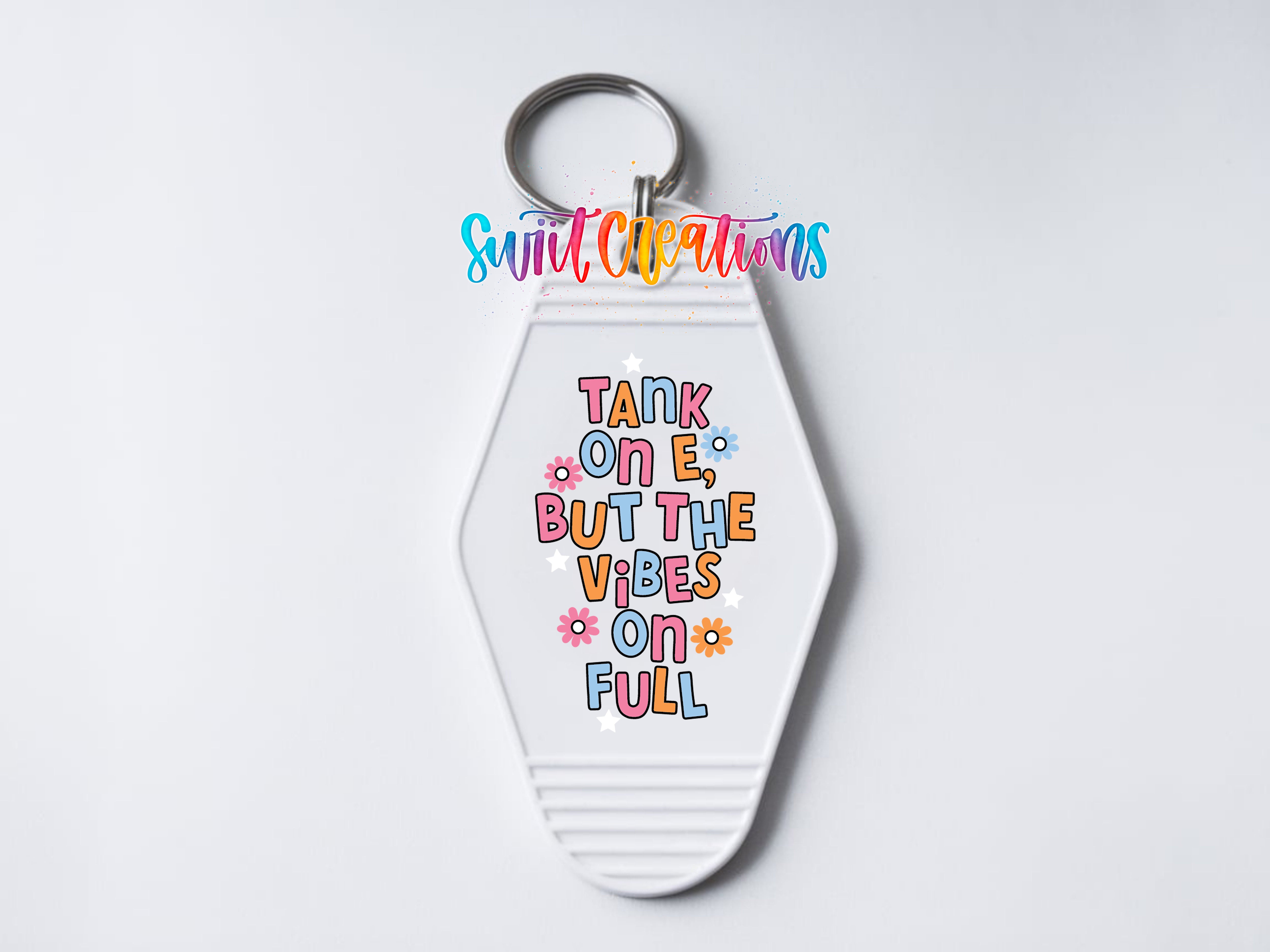 A keychain with a colorful design and text on it.