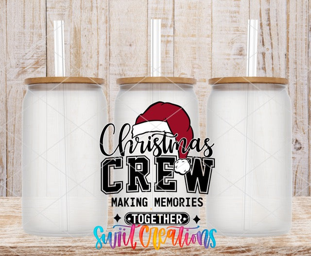 two christmas crew mugs sitting on top of a wooden table