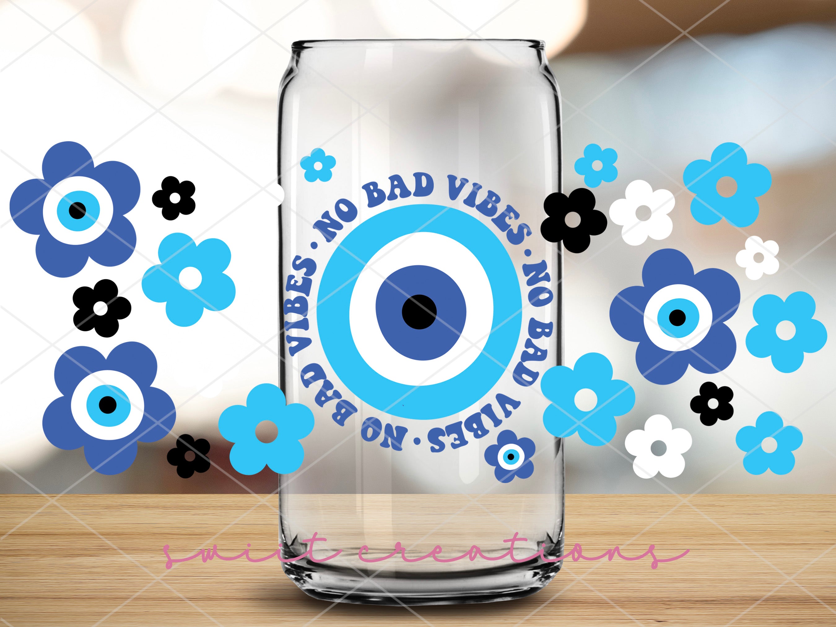 a glass with an eyeball on it sitting on a table