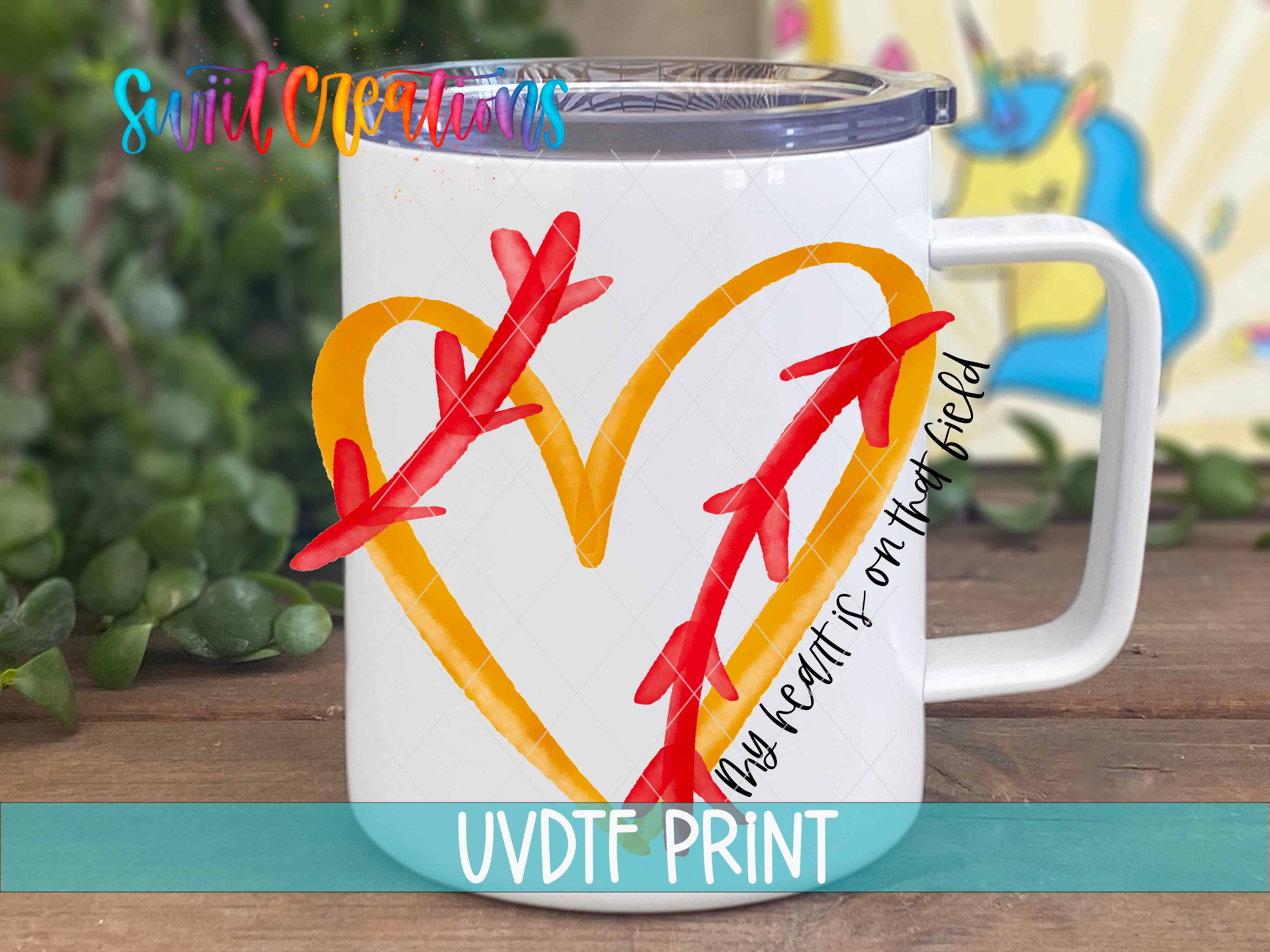 a white coffee mug with a heart and arrows painted on it