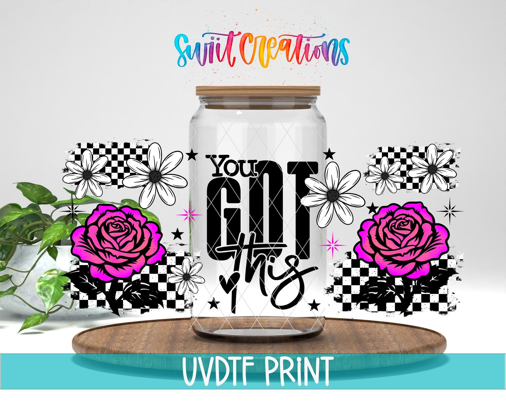 a clear glass jar with a wooden lid, surrounded by various floral and checkered designs. The text "You got this" is prominently displayed on the jar, along with a colorful and playful design. The background includes a plant and a wooden surface, creating a visually appealing and uplifting scene.