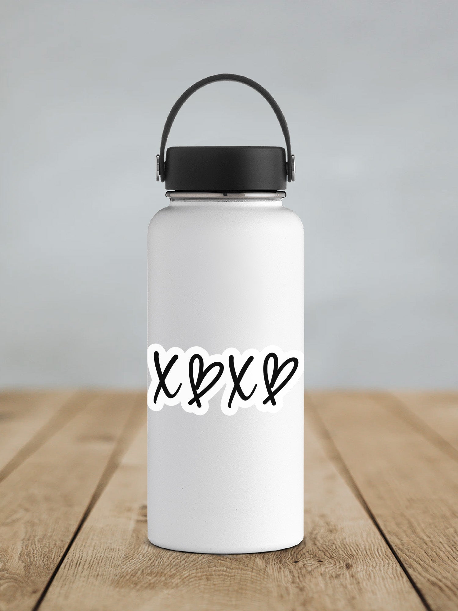 a white water bottle sitting on top of a wooden table
