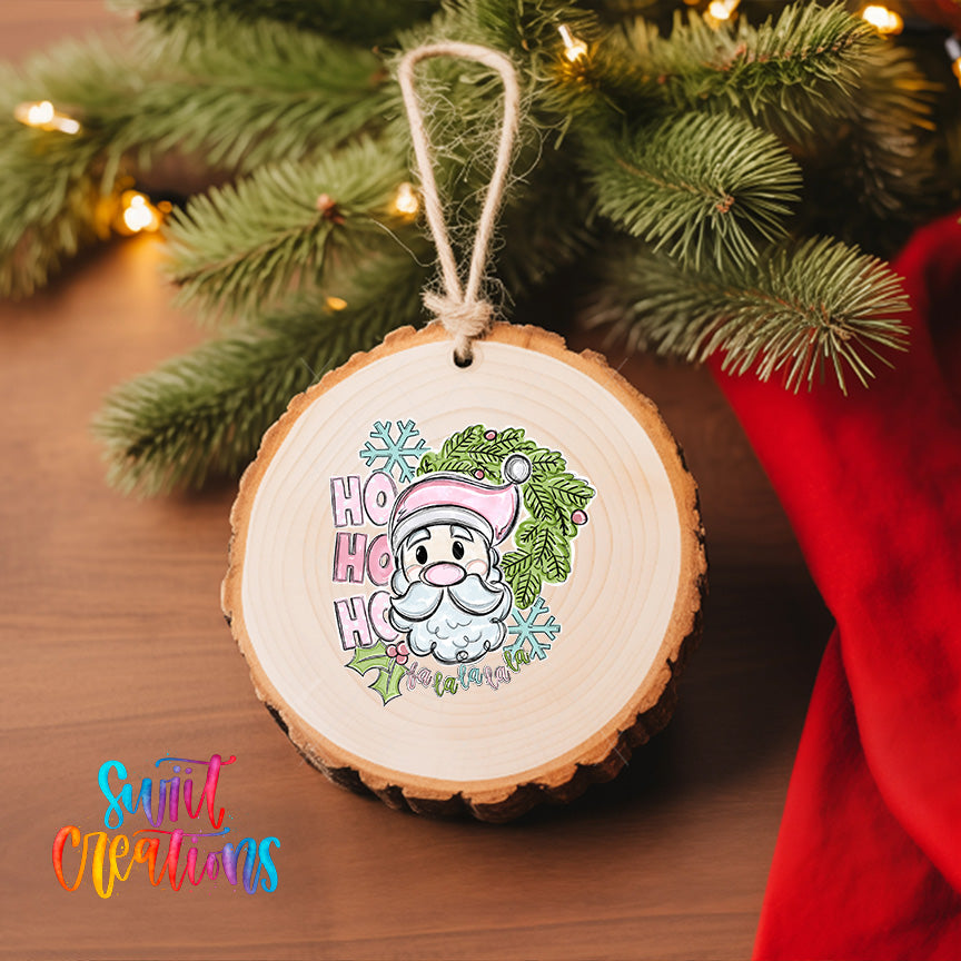A wooden ornament with a Santa Claus face and the text "Hoo ho ho" is hanging on a Christmas tree.