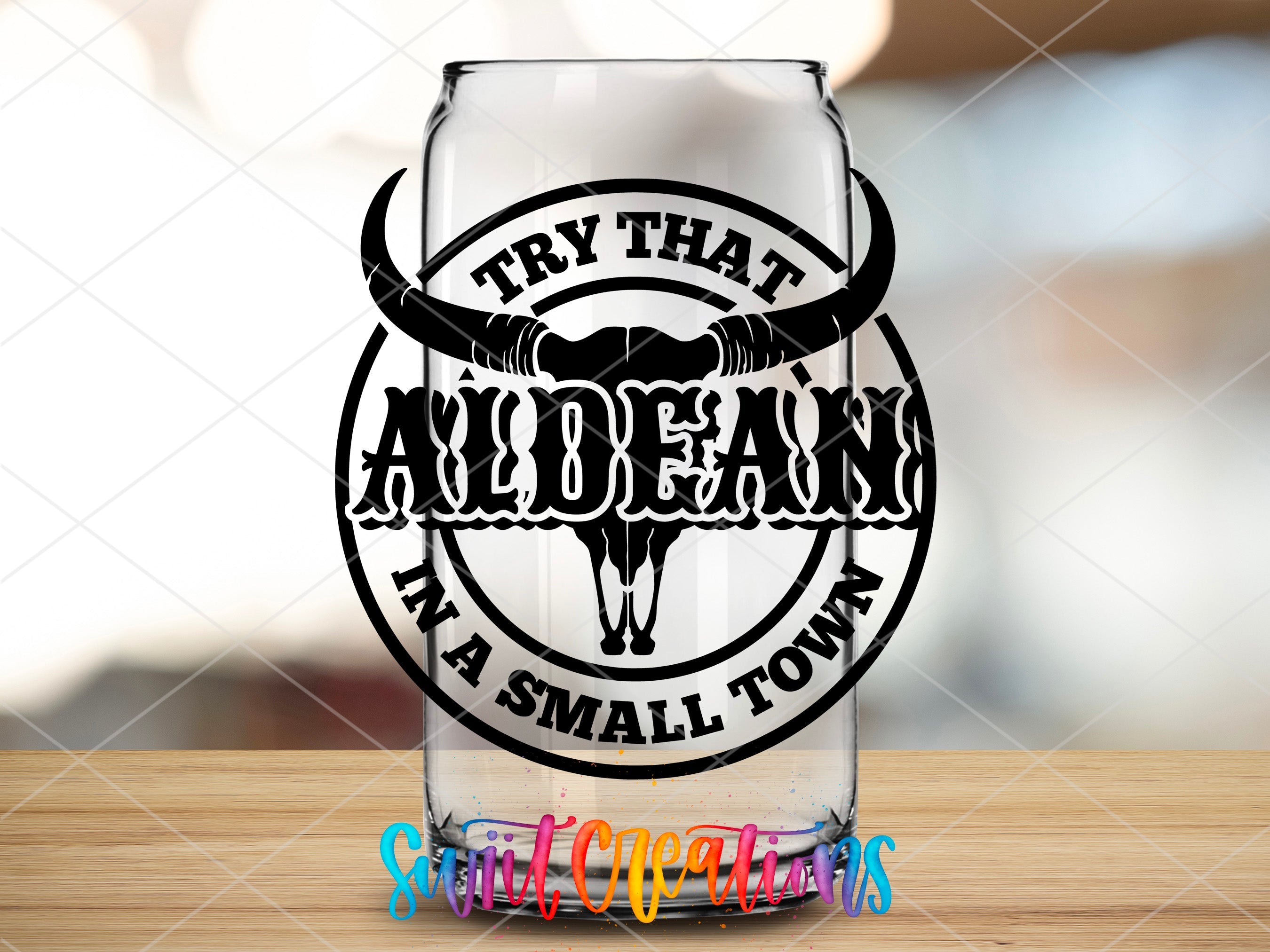a glass with a bull's head on it sitting on a table