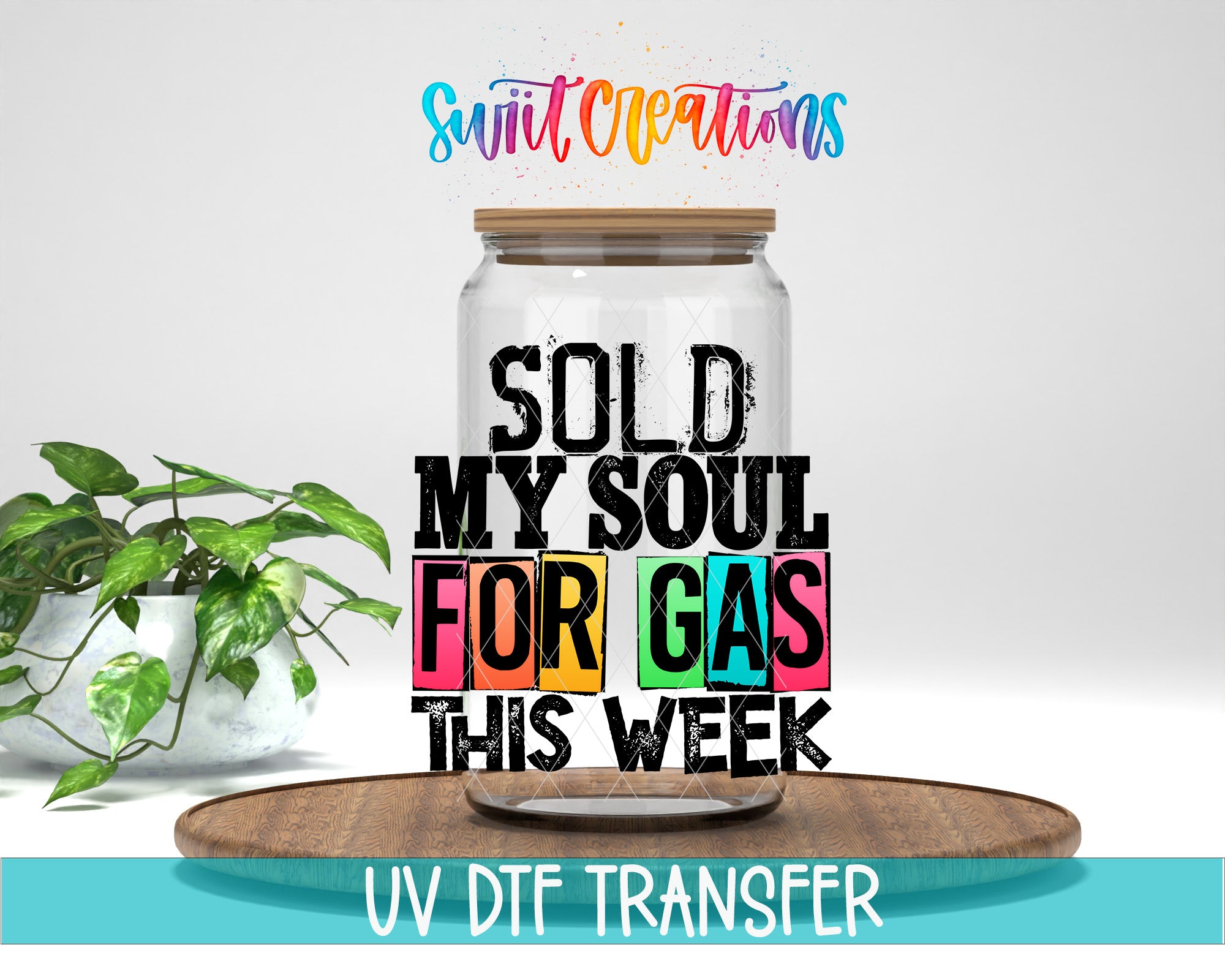 a large glass jar with a wooden lid, placed on a wooden tray. The jar is filled with colorful text that reads "SOLD MY SOUL FOR GAS THIS WEEK" and "UV DFT TRANSFER".