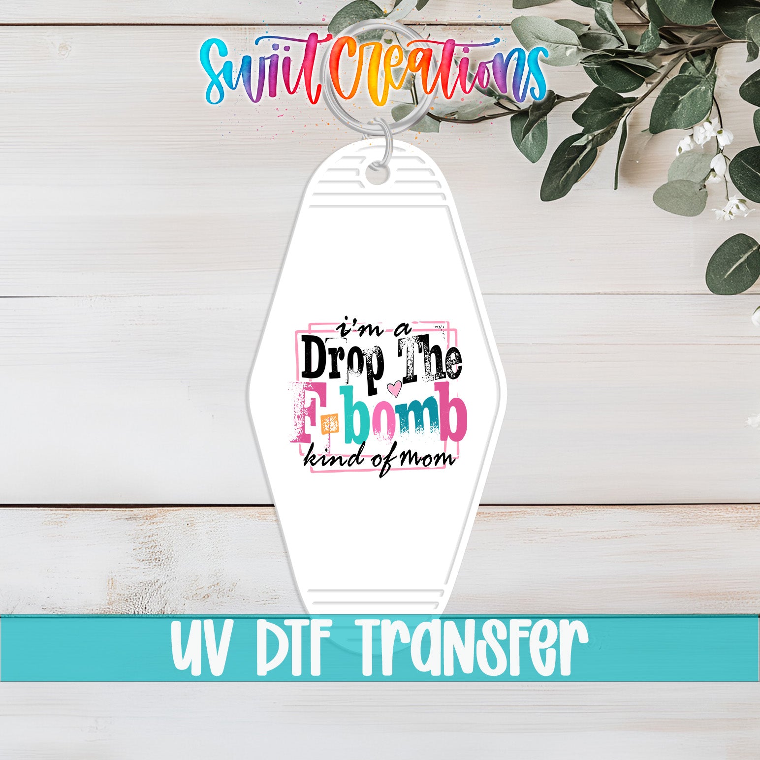 A keychain with a colorful text design that says "I'm a Drop The bombs kind of mom" and "UV Dtf Transfer".