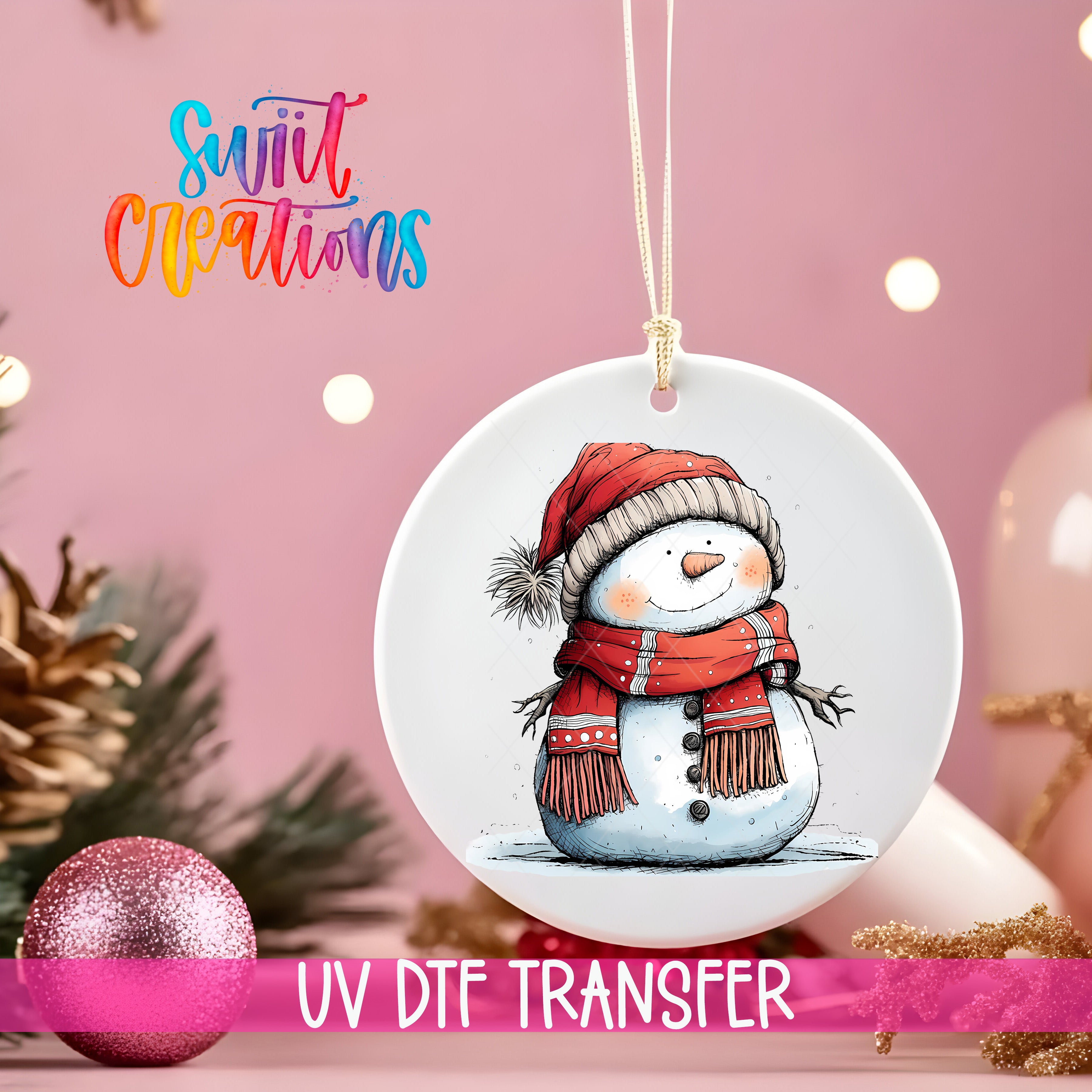 A white ceramic ornament with a snowman illustration is hanging on a string, surrounded by Christmas decorations and a pink background.