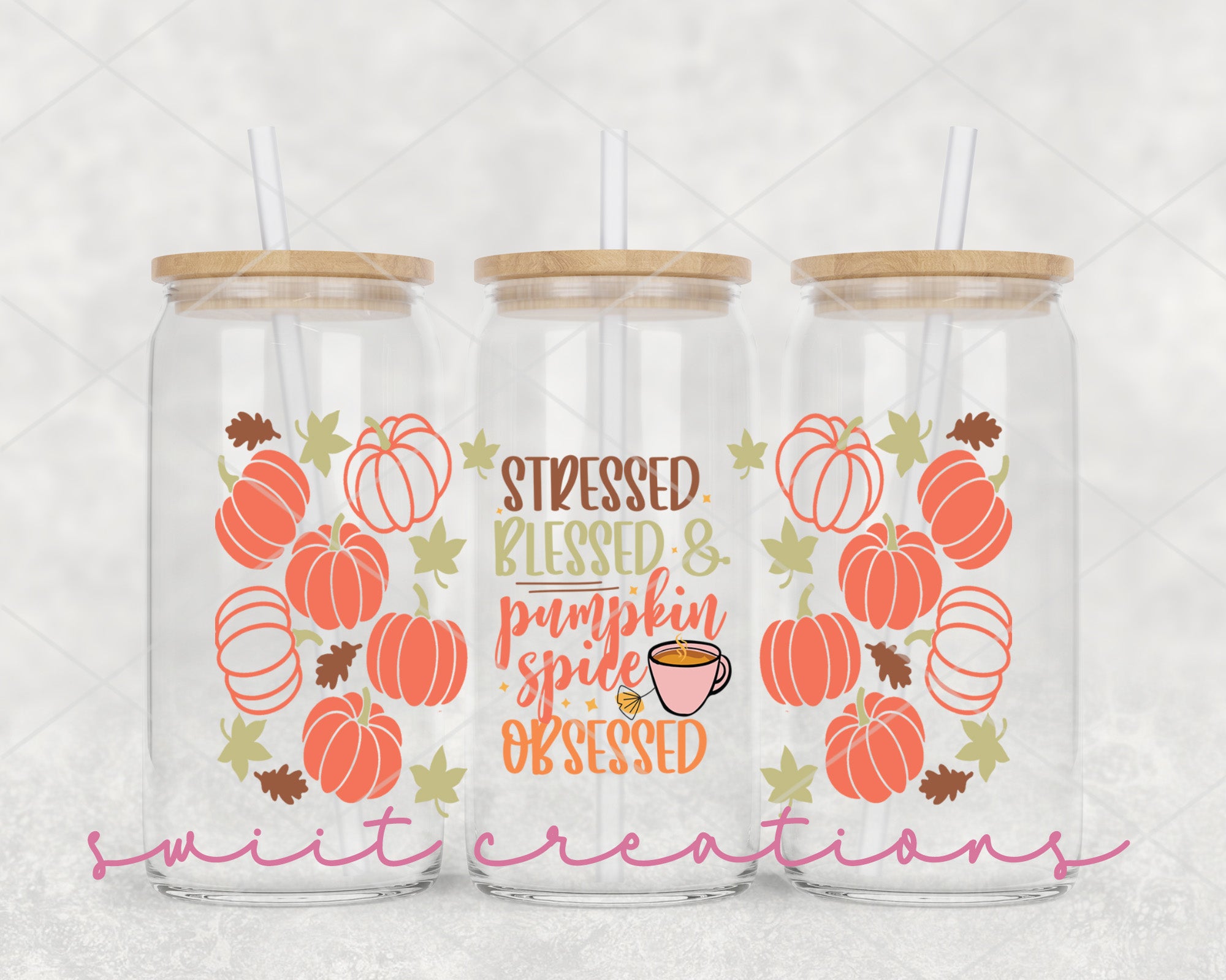 a set of three glass tumblers with pumpkins on them
