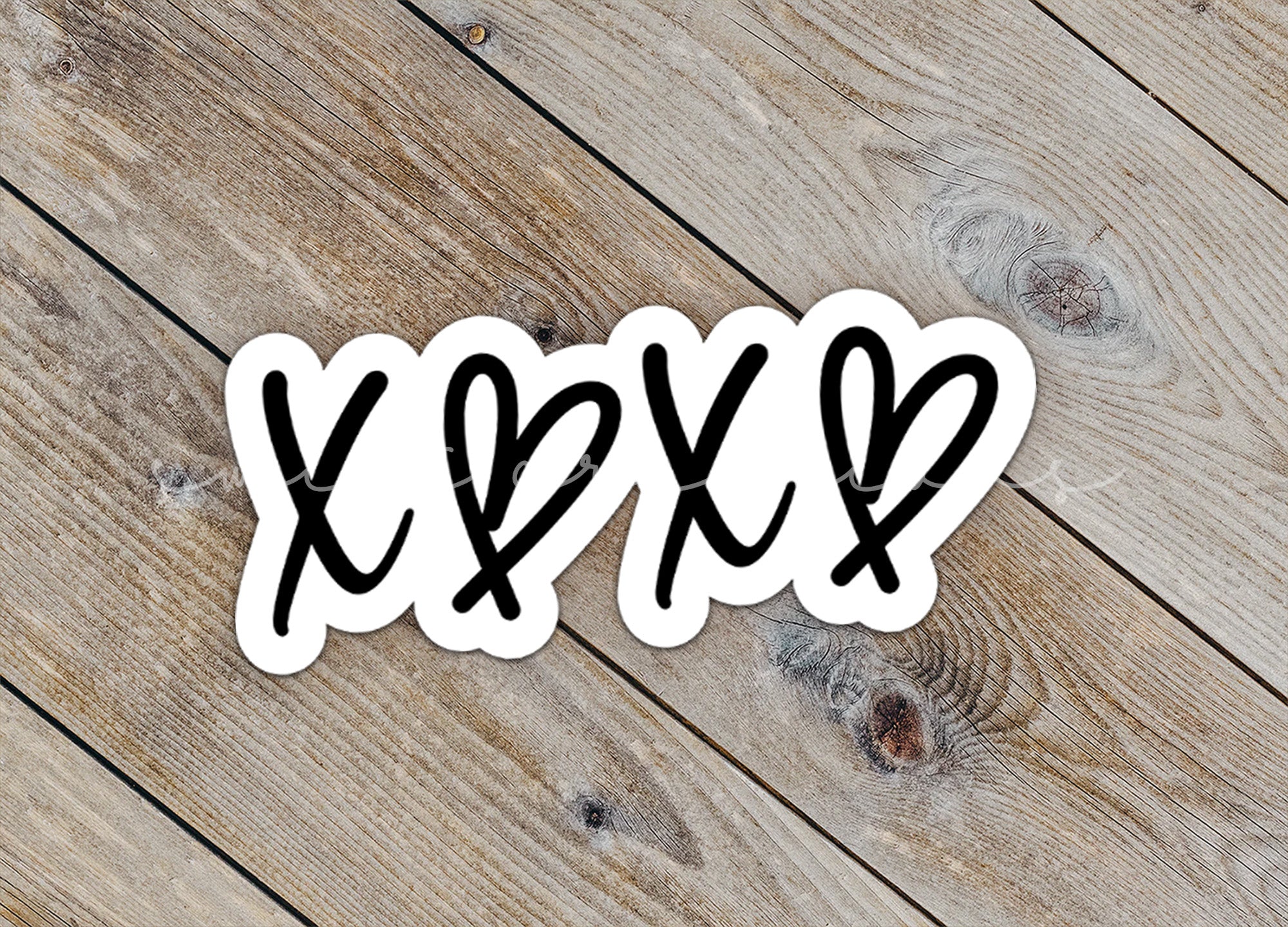 a close up of a sticker on a wooden surface