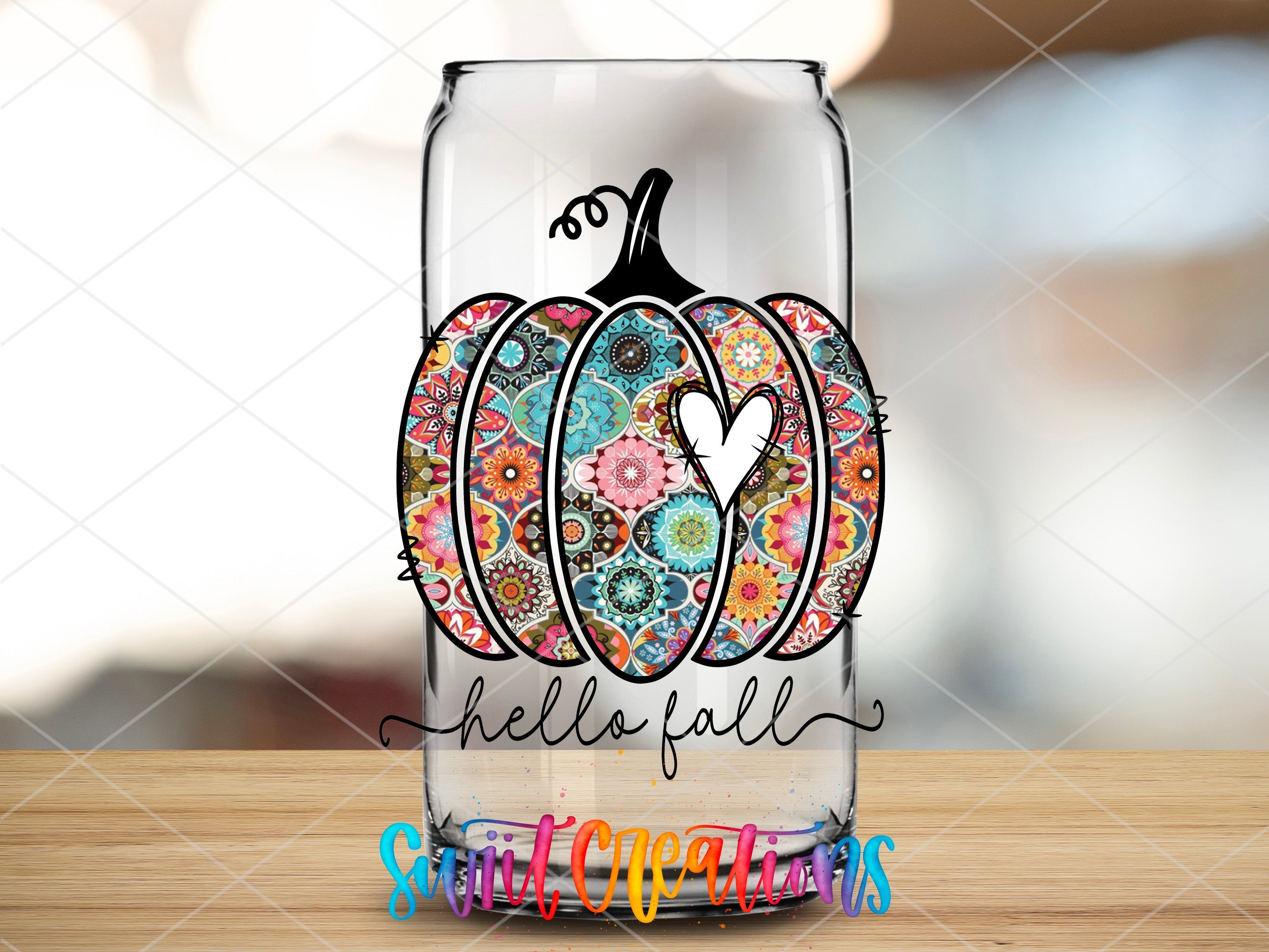 a glass with a painted pumpkin on it