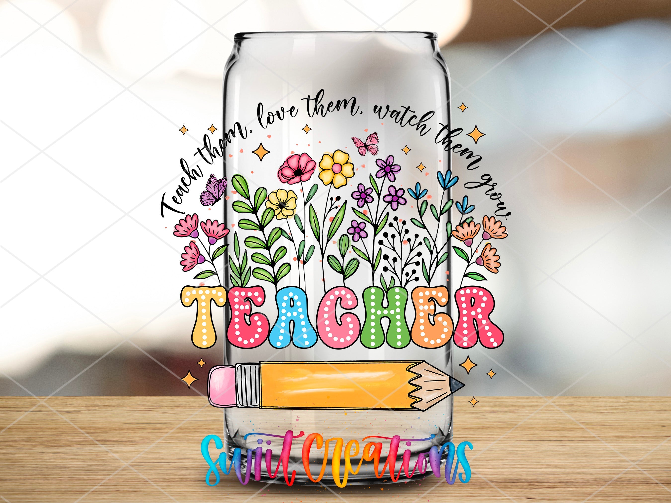 a clear glass with a drawing of flowers and a pencil