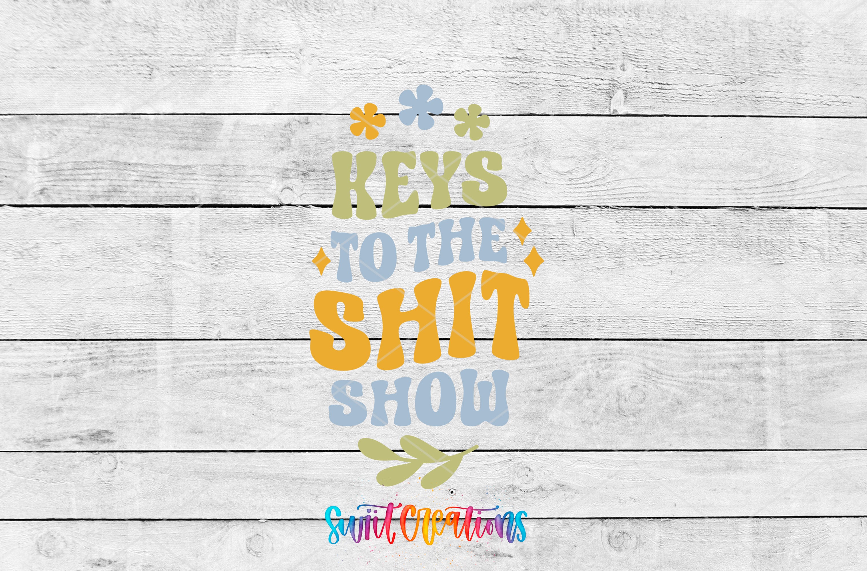 a colorful and playful text that reads "Keys to the shit show" against a white wooden background.
