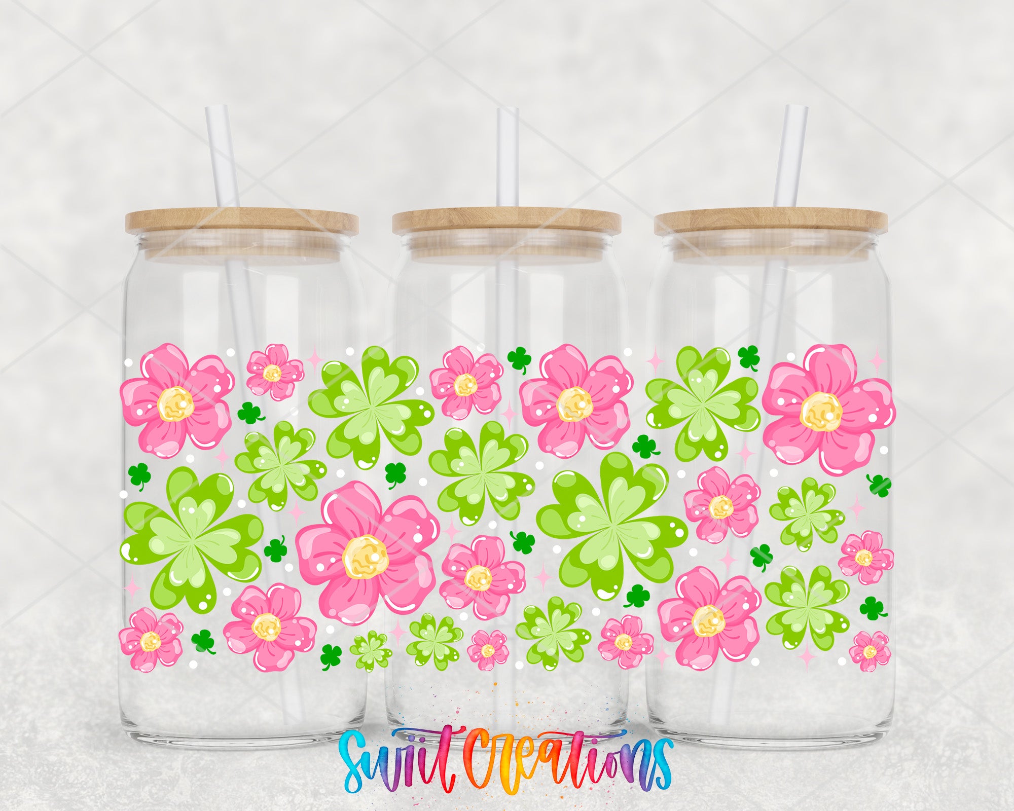 Three glass jars with lids, each containing a colorful arrangement of pink and green flowers with clover leaves.