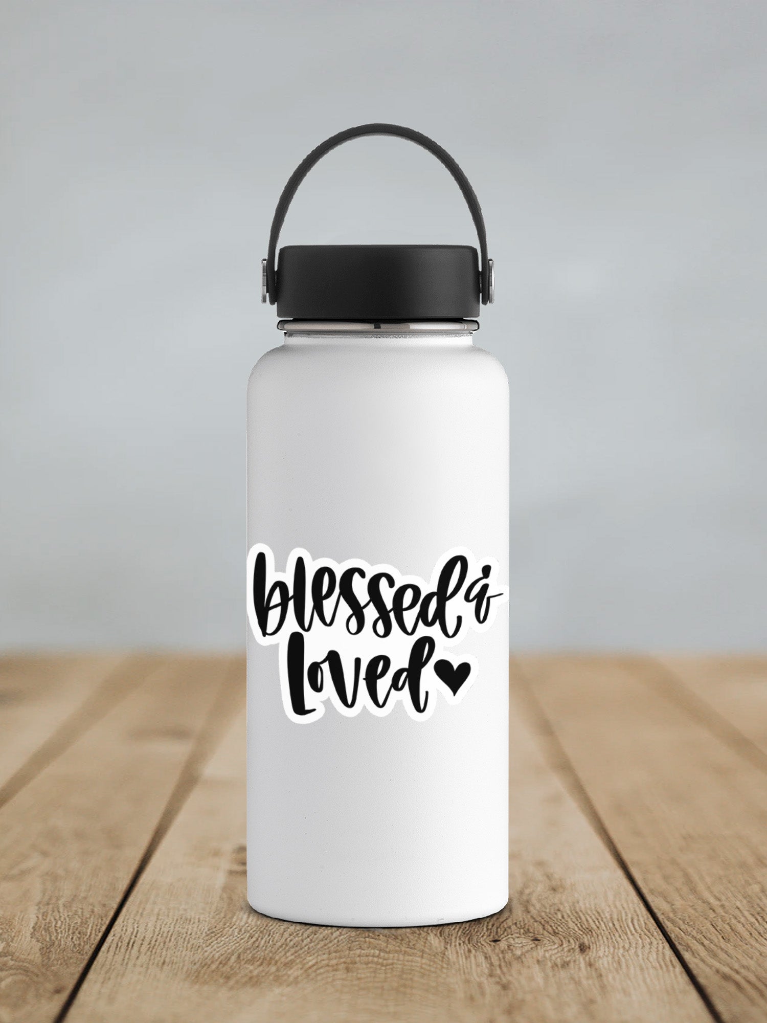 a white water bottle sitting on top of a wooden table