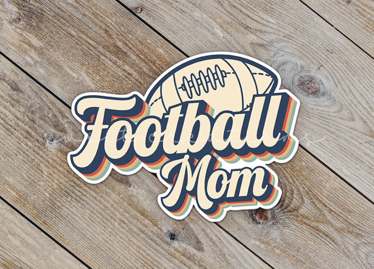 Close-up of the Football Mom sticker on rustic wood