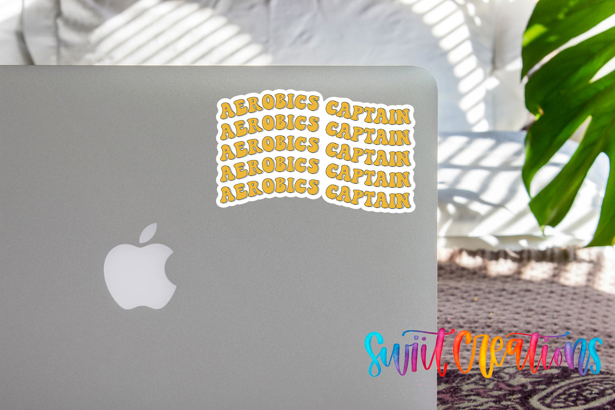 a sticker with the phrase "AEROBICS CAPTAIN" repeated multiple times on the cover of a laptop.
