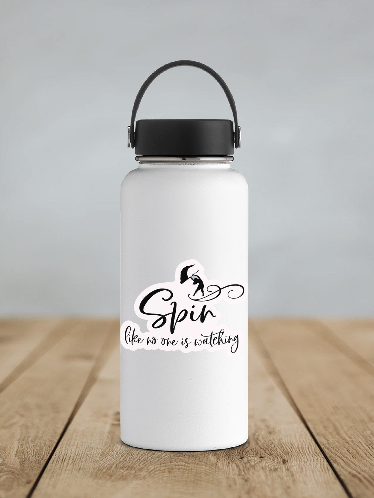 a white water bottle sitting on top of a wooden table