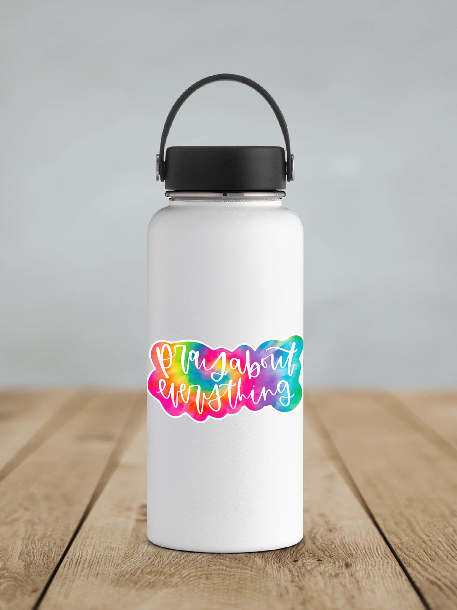 a white water bottle with a black lid on a wooden table