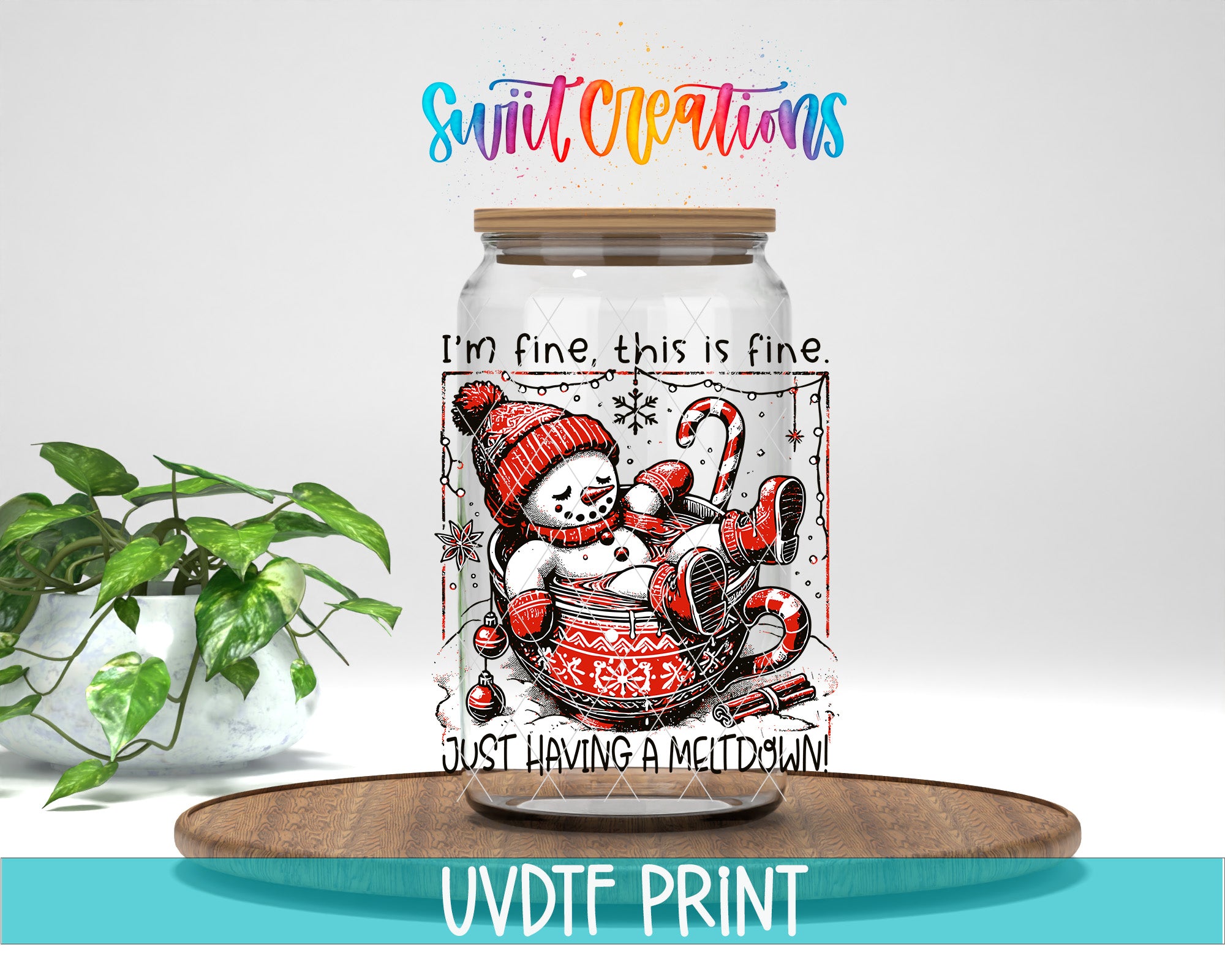 A glass jar with a snowman design and the text "I'm fine, this is fine. Just having a Meltdown!" printed on it, placed on a wooden surface next to a potted plant.