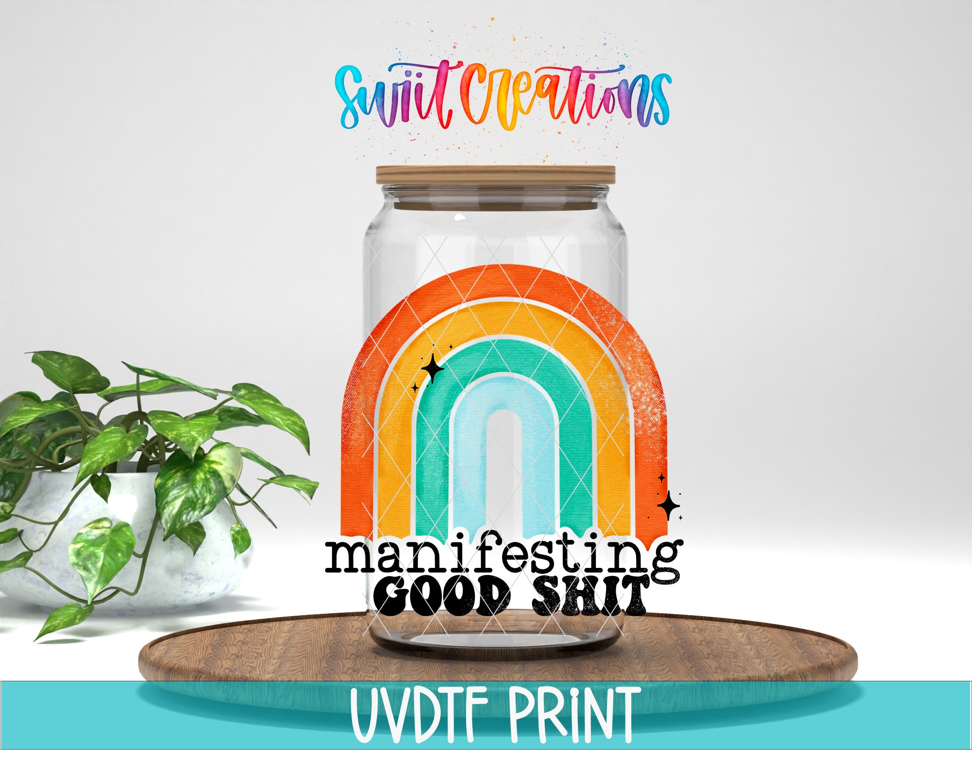a glass jar with a rainbow design, placed on a wooden surface. The jar has a lid and is surrounded by a potted plant. The text above the jar reads "Swift Creations" and "manifesting GOOD SHIT". The text below the jar says "UVDF PRINT".