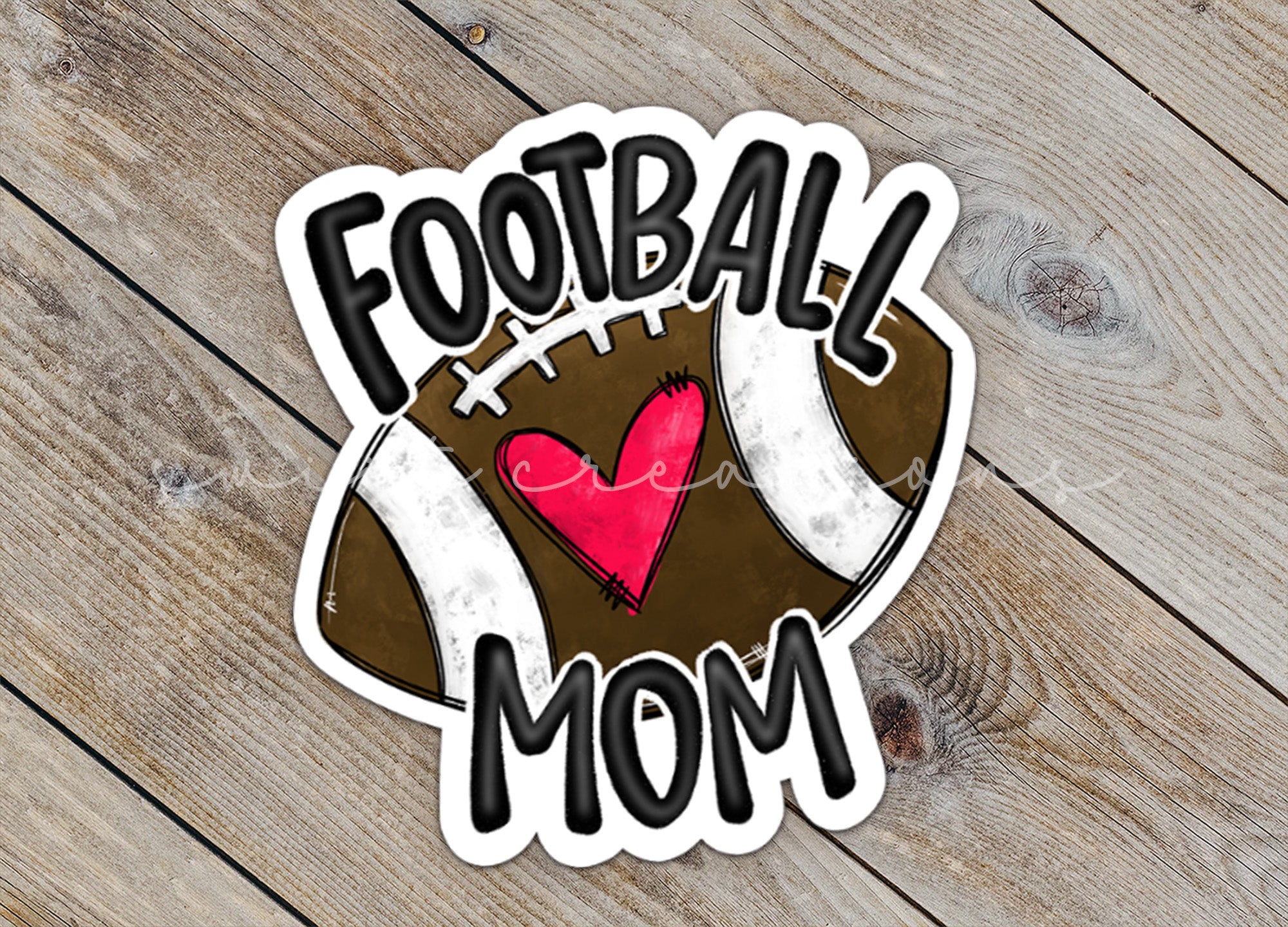a football mom sticker on a wooden surface