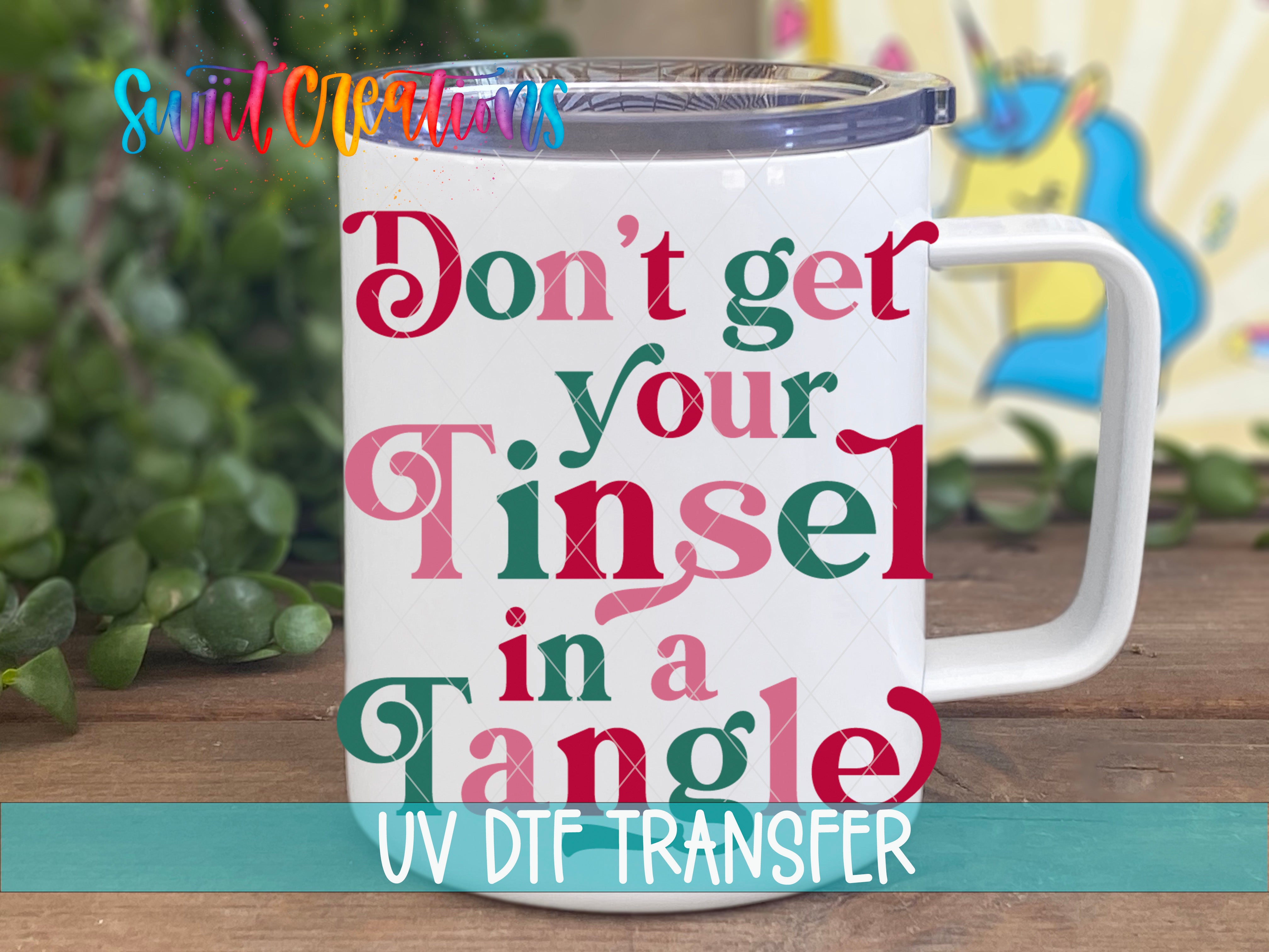 A white mug with colorful text printed on it, placed on a wooden surface.