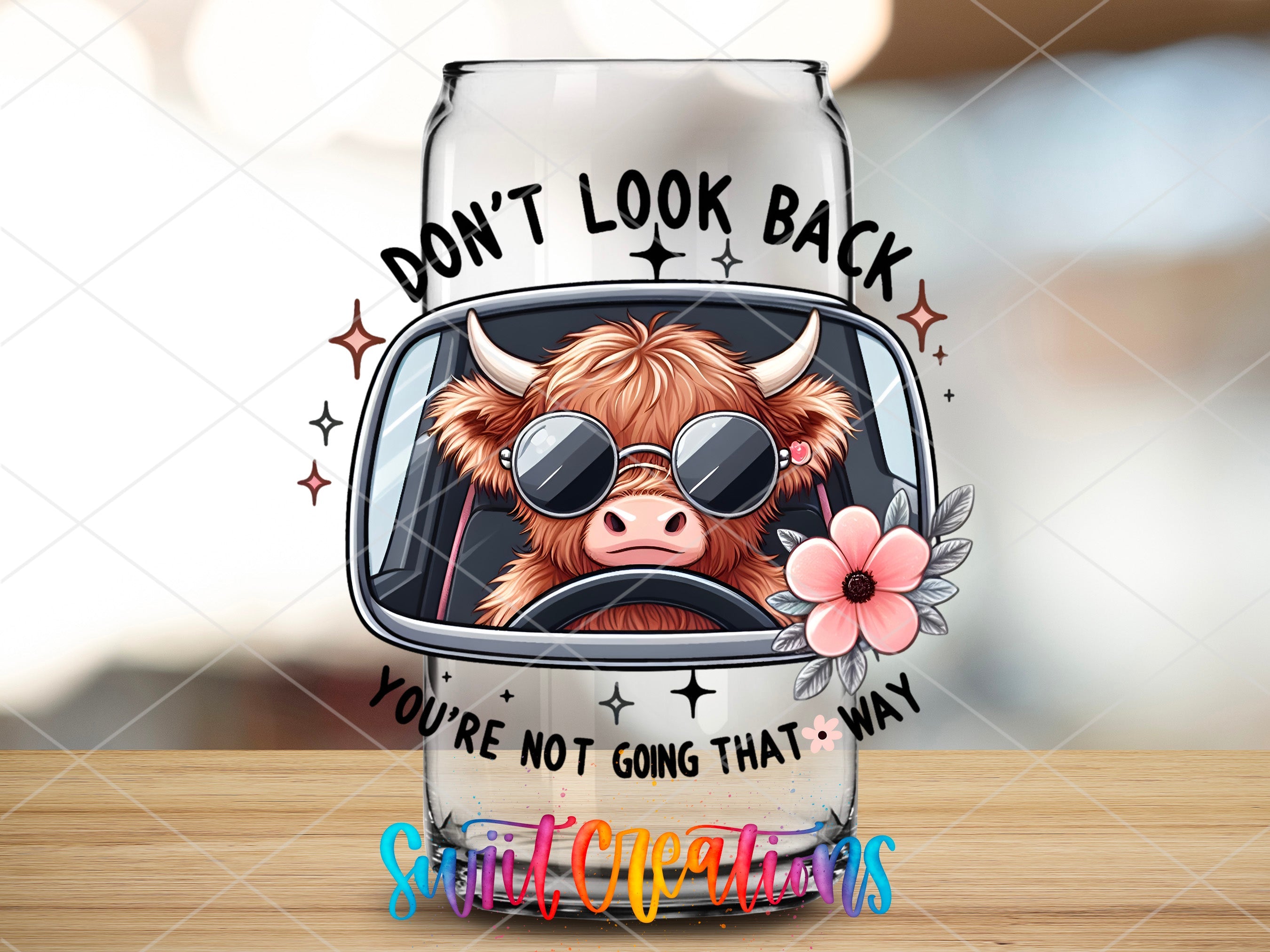 a glass with a cow wearing sunglasses on it