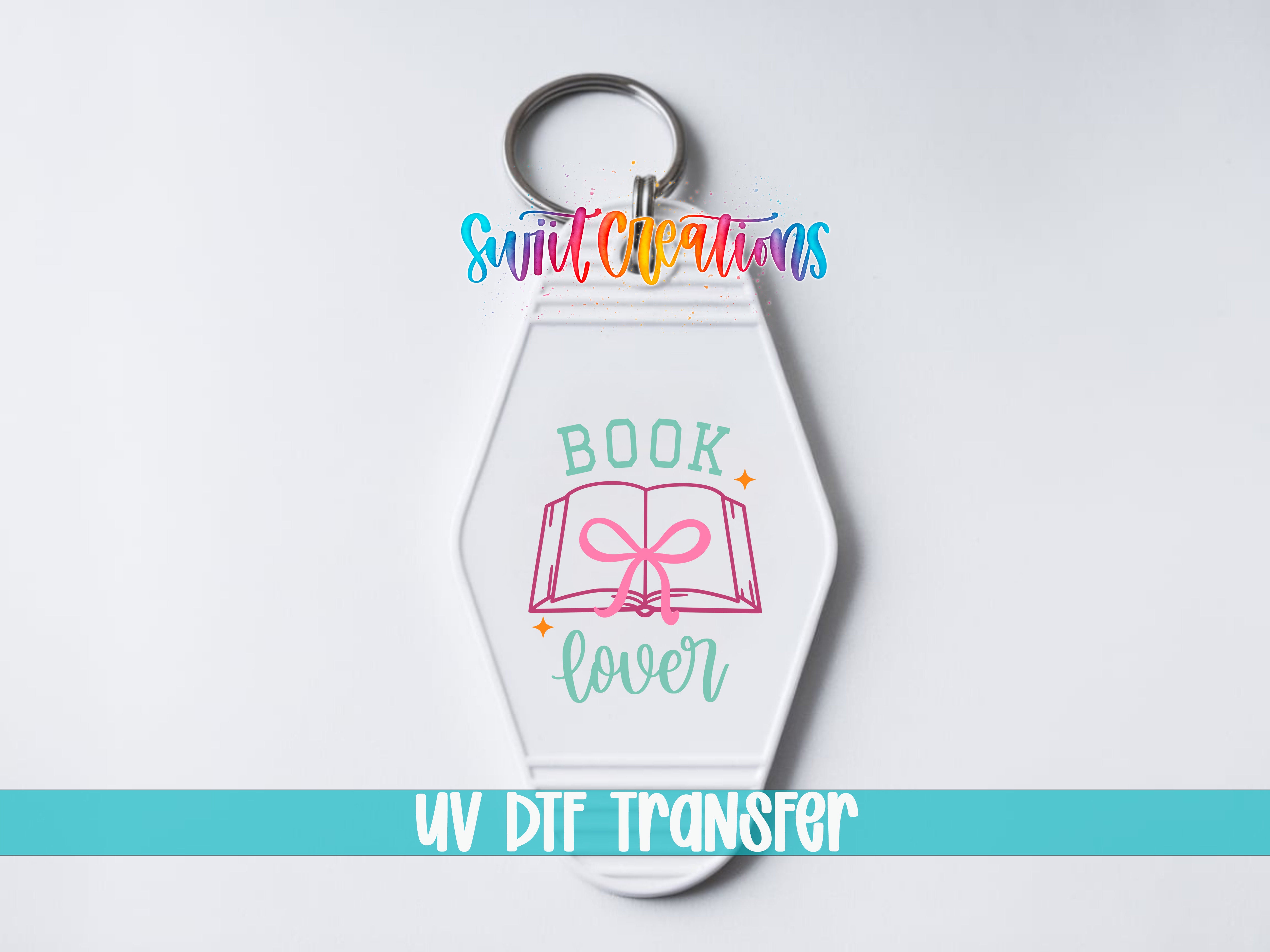 A keychain with a book and the text "Book lover" printed on it, along with a logo and the text "Sunlit Creations" and "UV DDF Transfer".