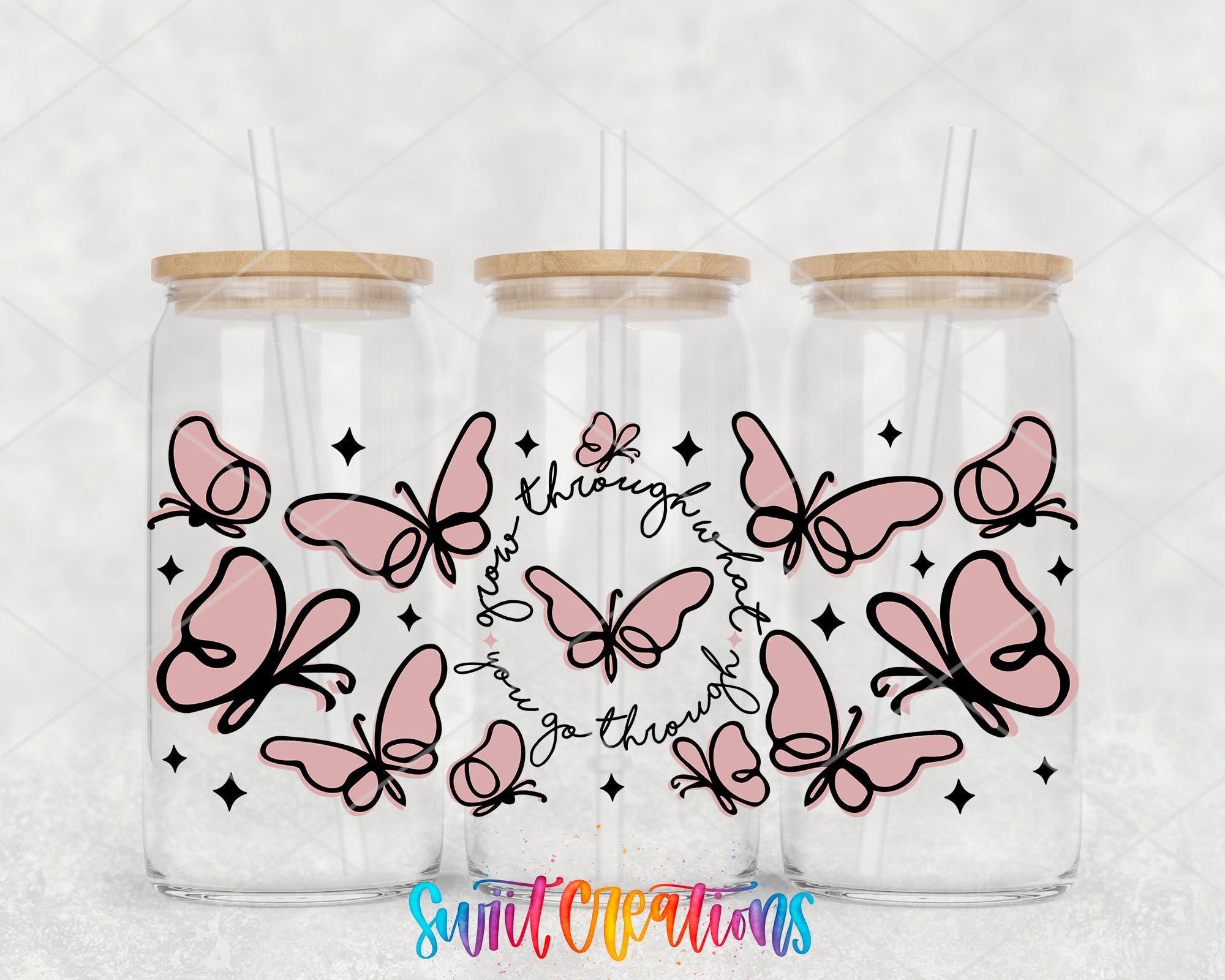 Three glass tumblers with wooden lids, each decorated with pink butterflies and stars. The text "You go through" is written around the butterflies, and the background is a light gray color.
