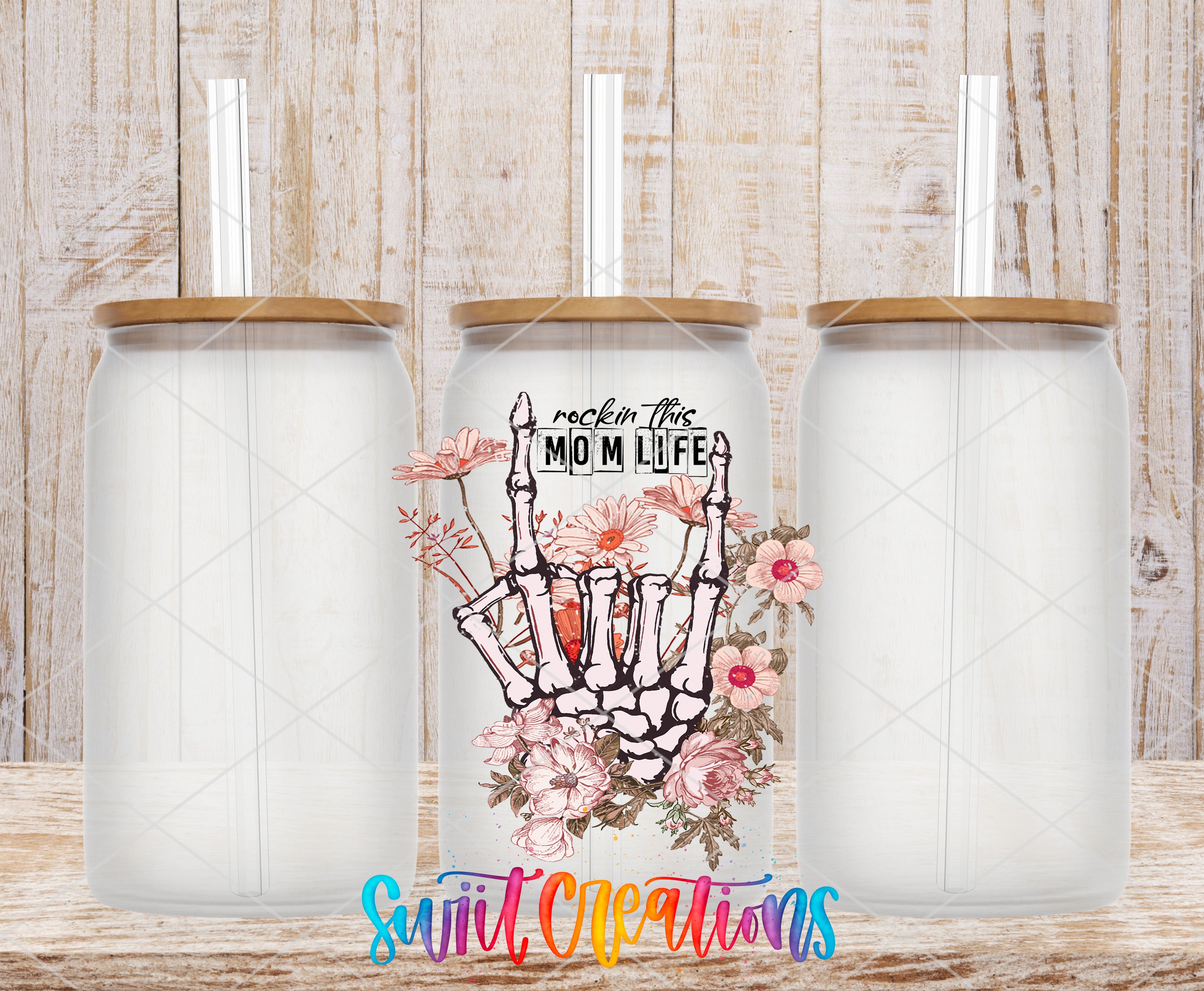 three glass tumblers with a floral design and the text "rock this Mom life" printed on them.