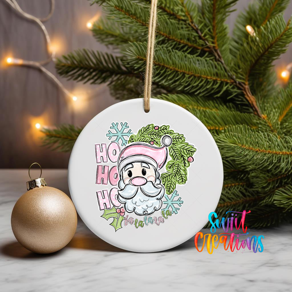 A white ceramic ornament with a Santa Claus face and the text "HOOK HOOK" is displayed on a table, surrounded by a Christmas tree and a gold ornament.