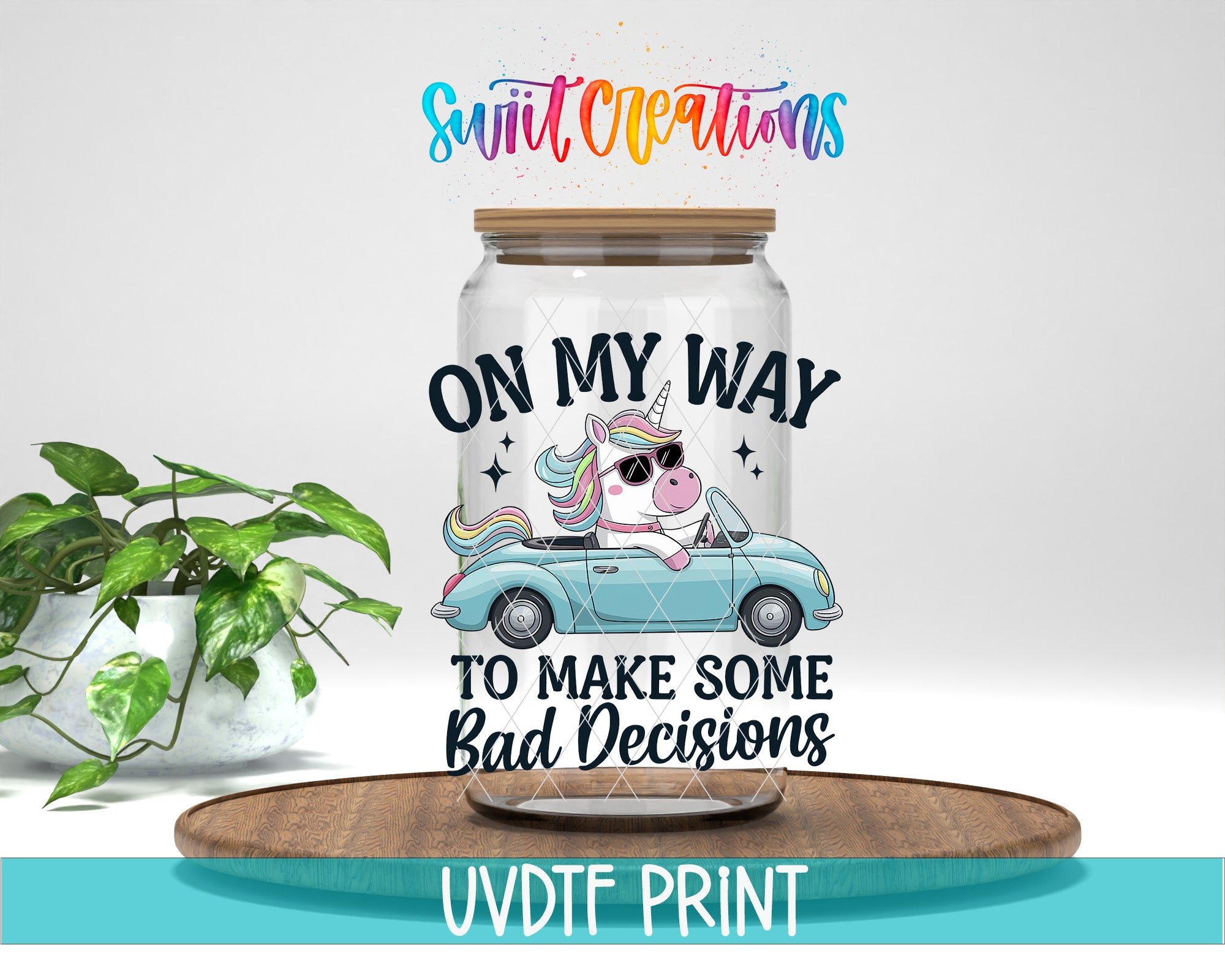 a glass jar with a cartoon unicorn and the text "ON MY WAY TO MAKE SOME BAD DECISIONS" printed on it. The jar is placed on a wooden surface, and there is a potted plant in the background.