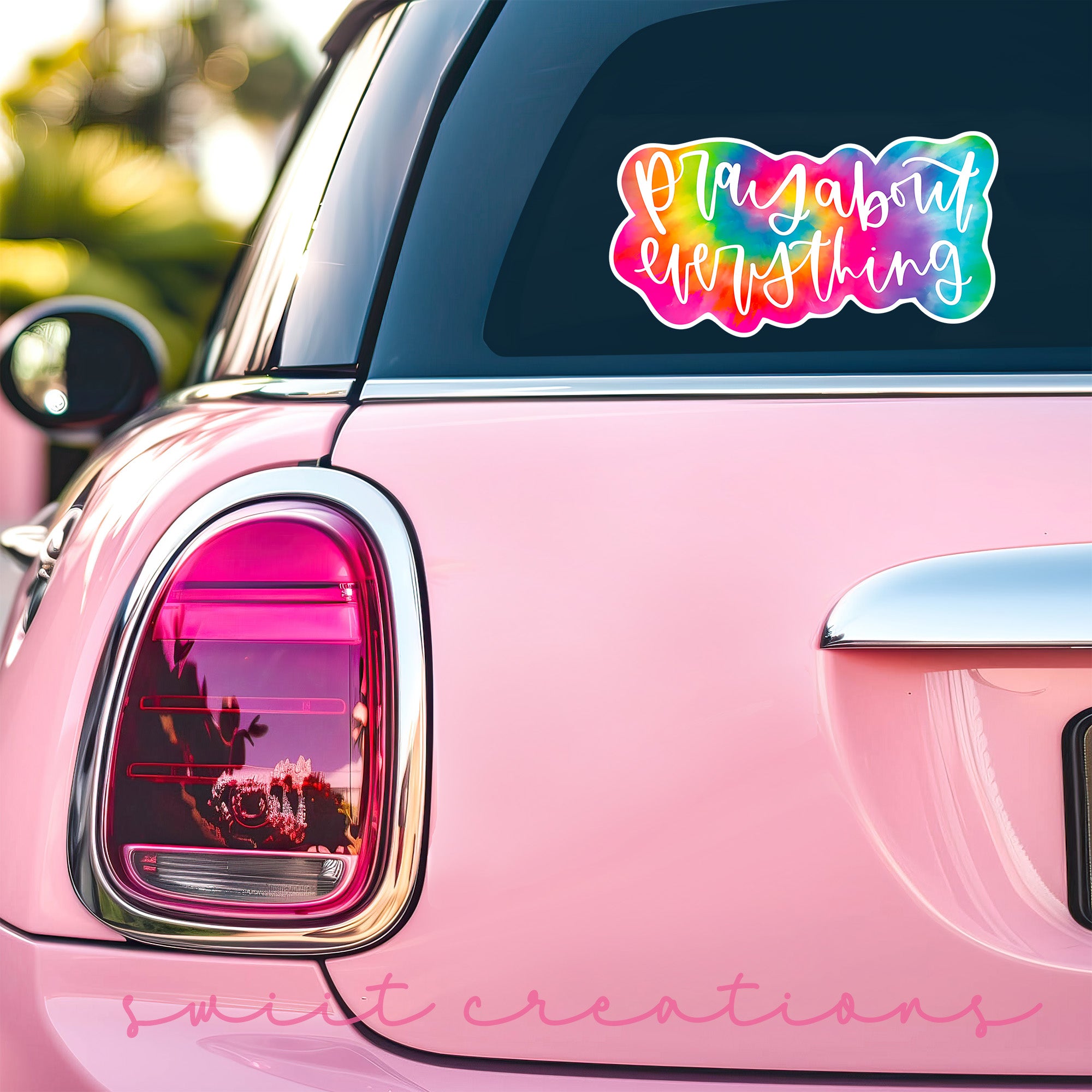 a pink car that has a sticker on it