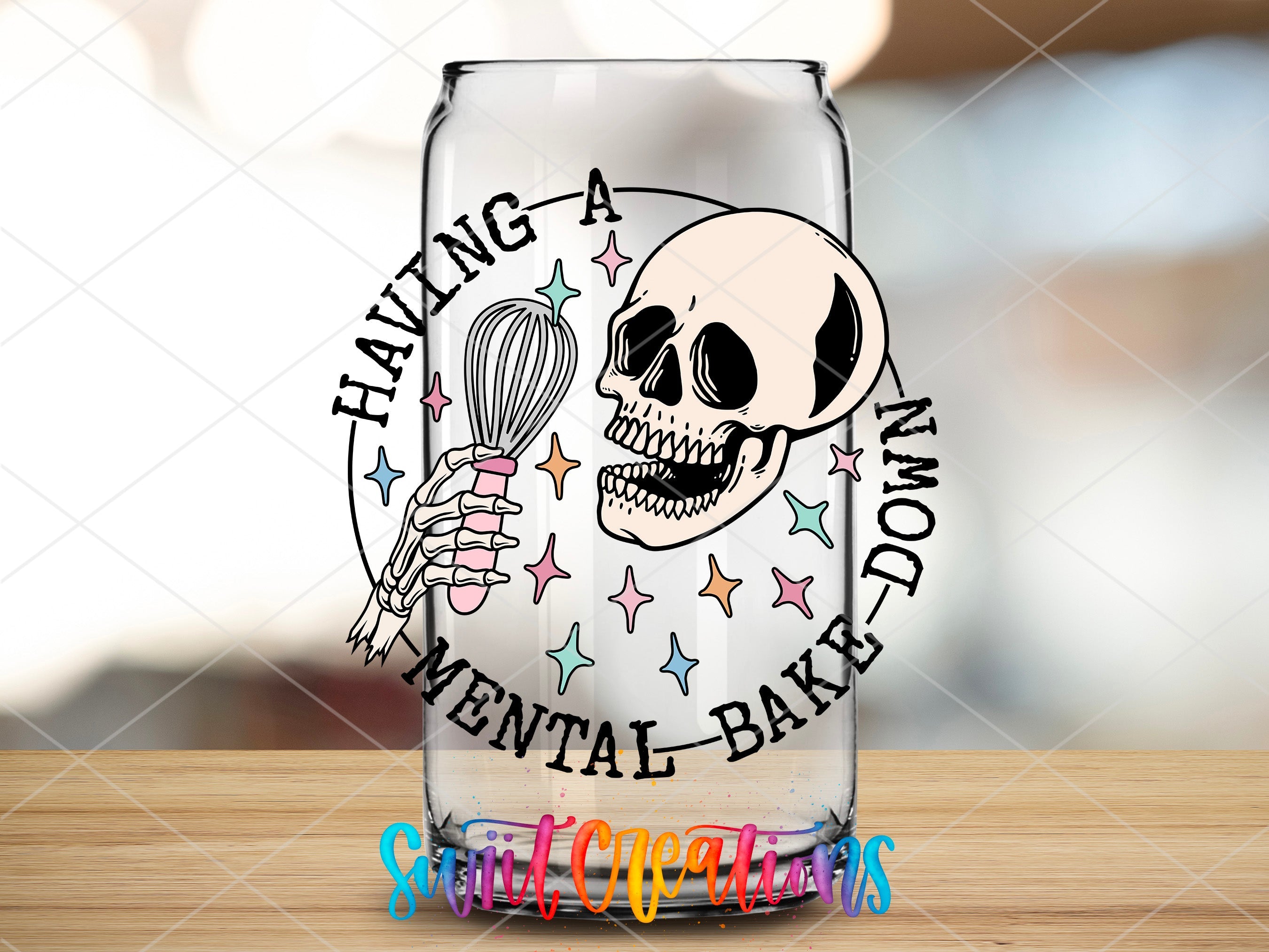 a glass with a skeleton holding a whisk in it