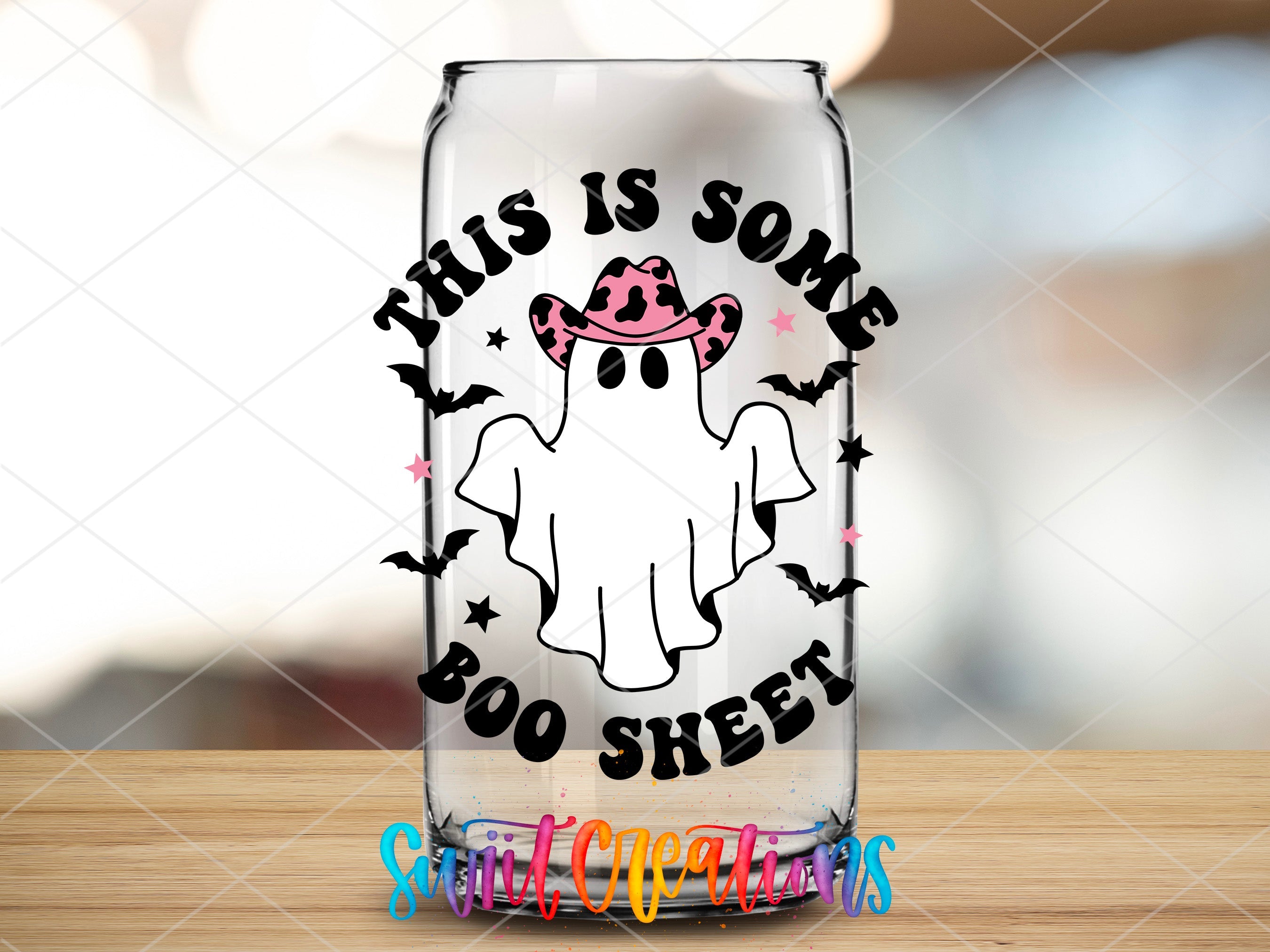 a glass with a ghost on it sitting on a table