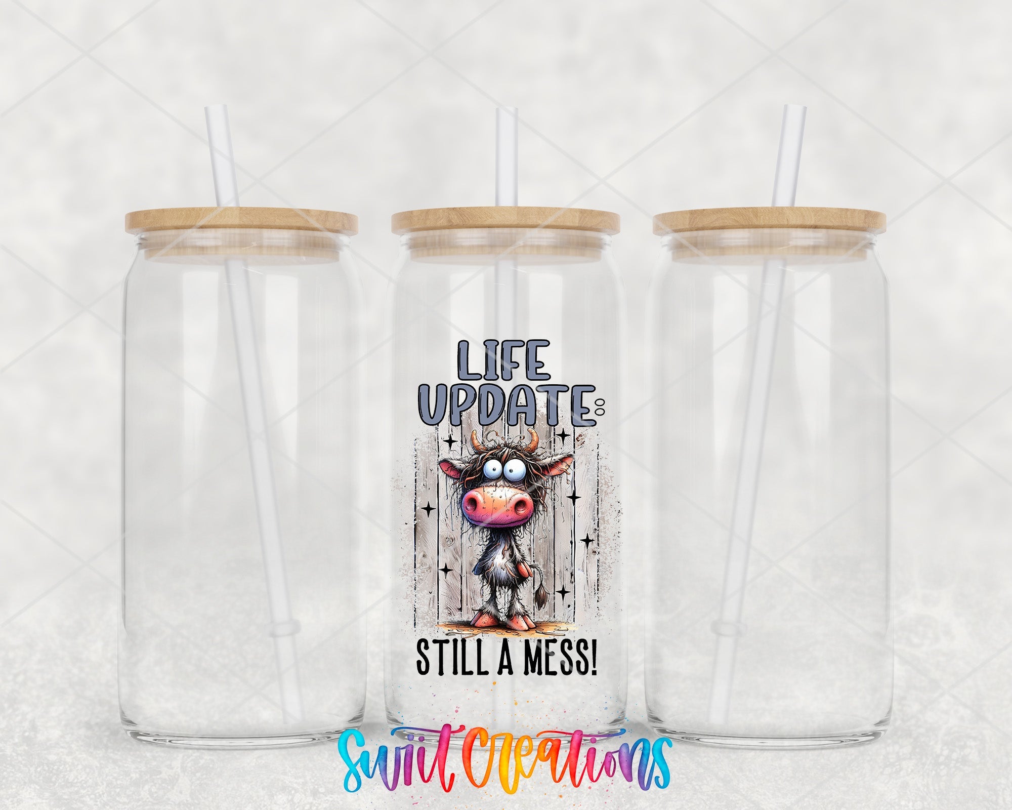 two clear tumblers with a cow on the side