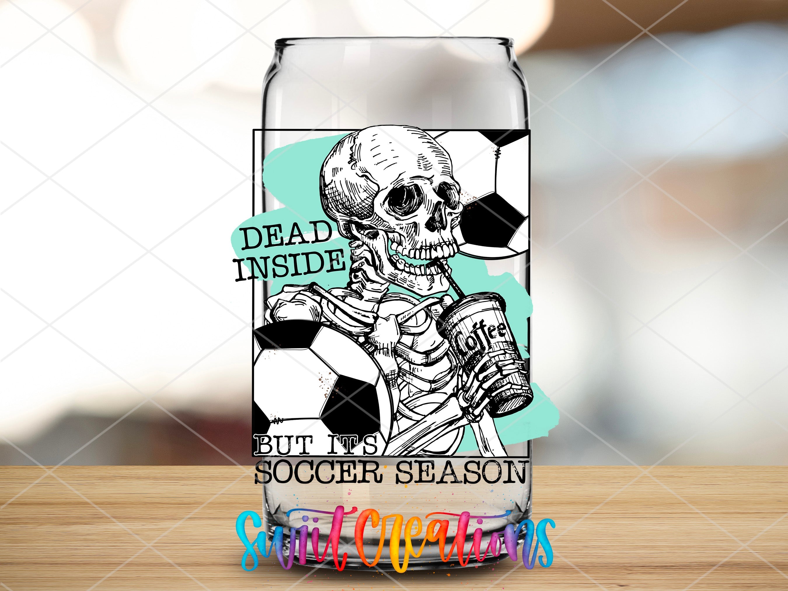 a glass with a skeleton holding a soccer ball