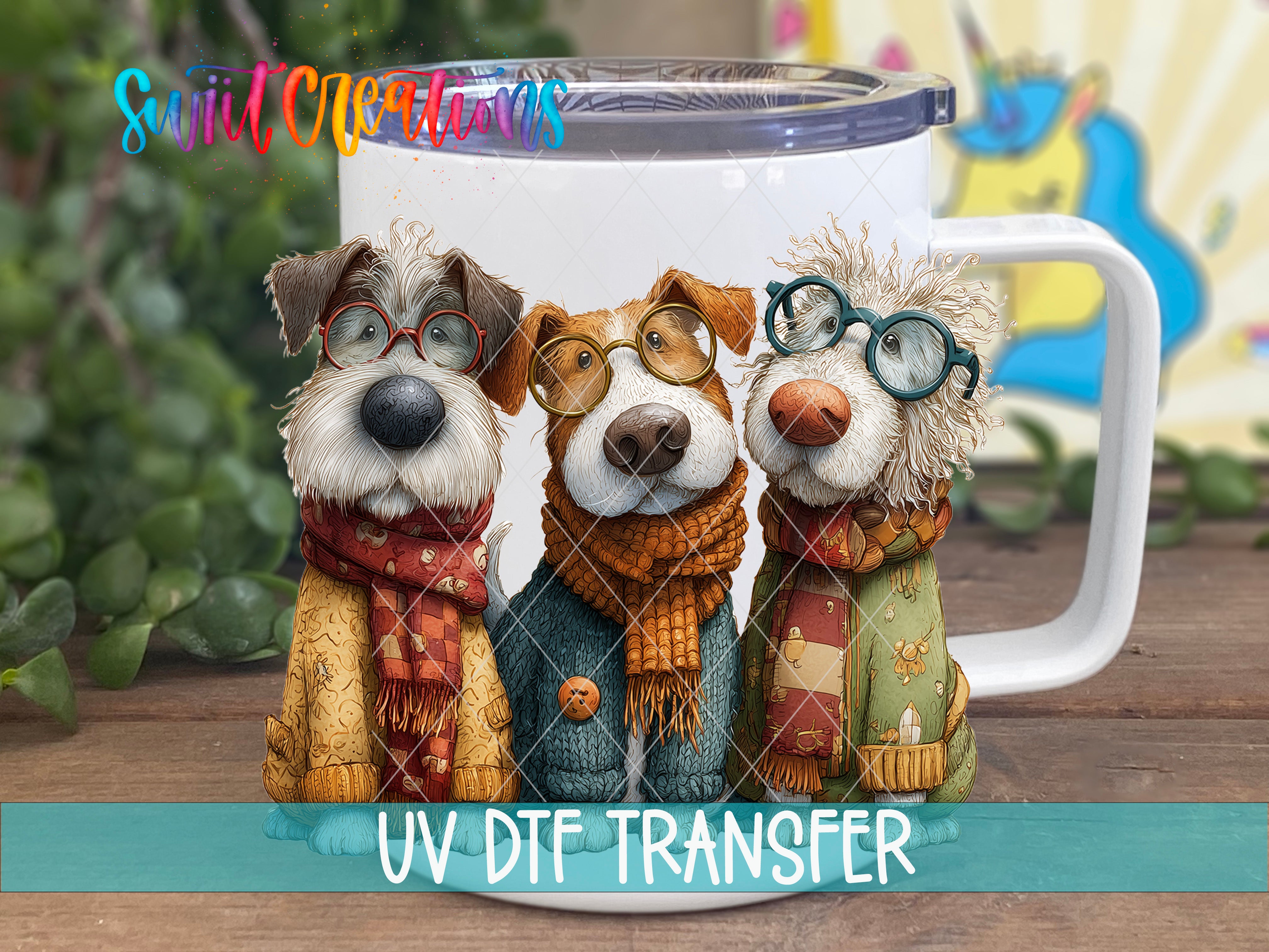 Three cute dog figurines wearing glasses and scarves, sitting together in front of a white mug with a UV DFT transfer label.